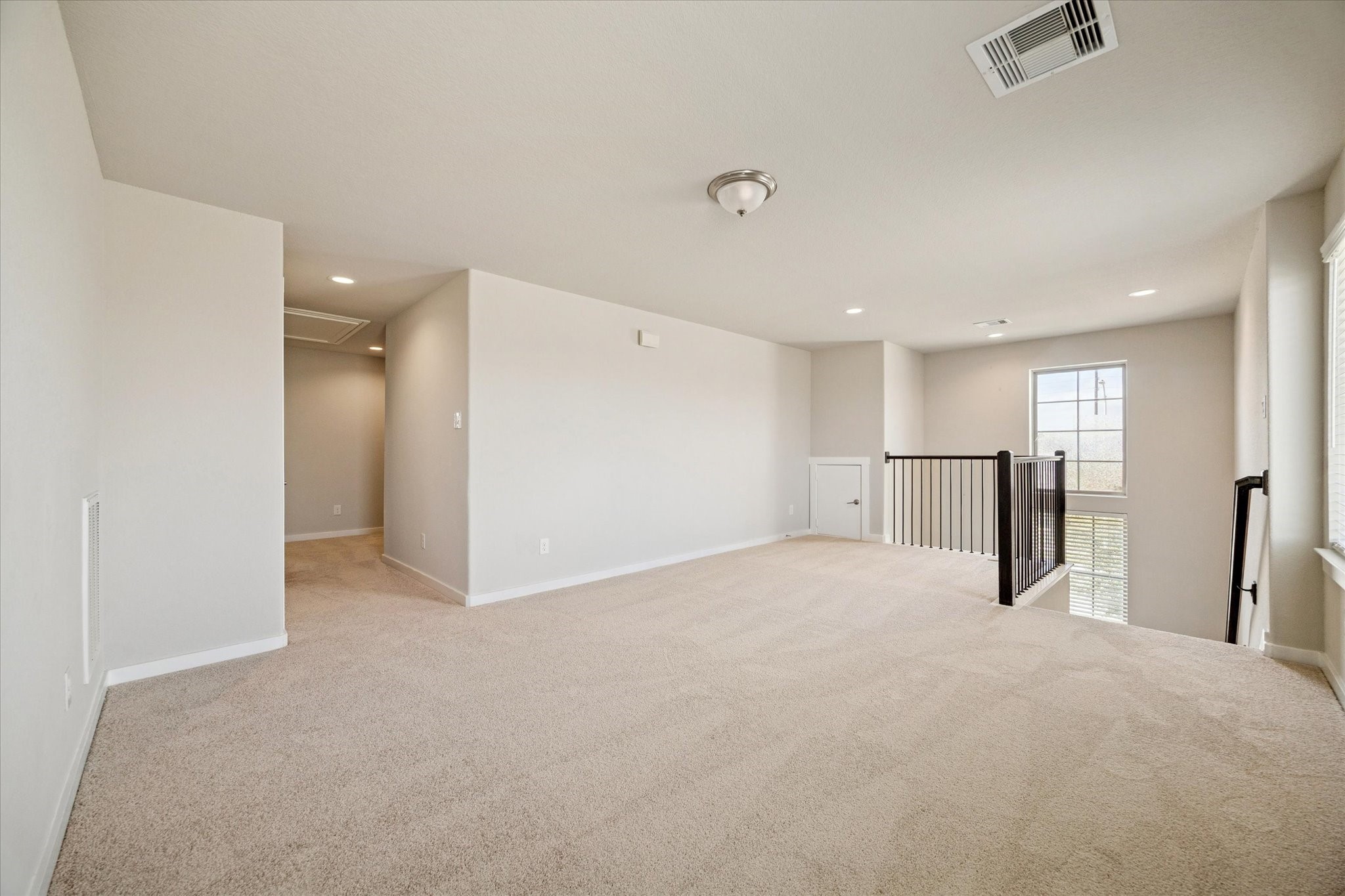 This spacious upper level room offers versatility for entertainment, media, or casual gatherings. Neutral finishes allow the space to evolve easily, whether used as a game room, workout area, or secondary living zone.