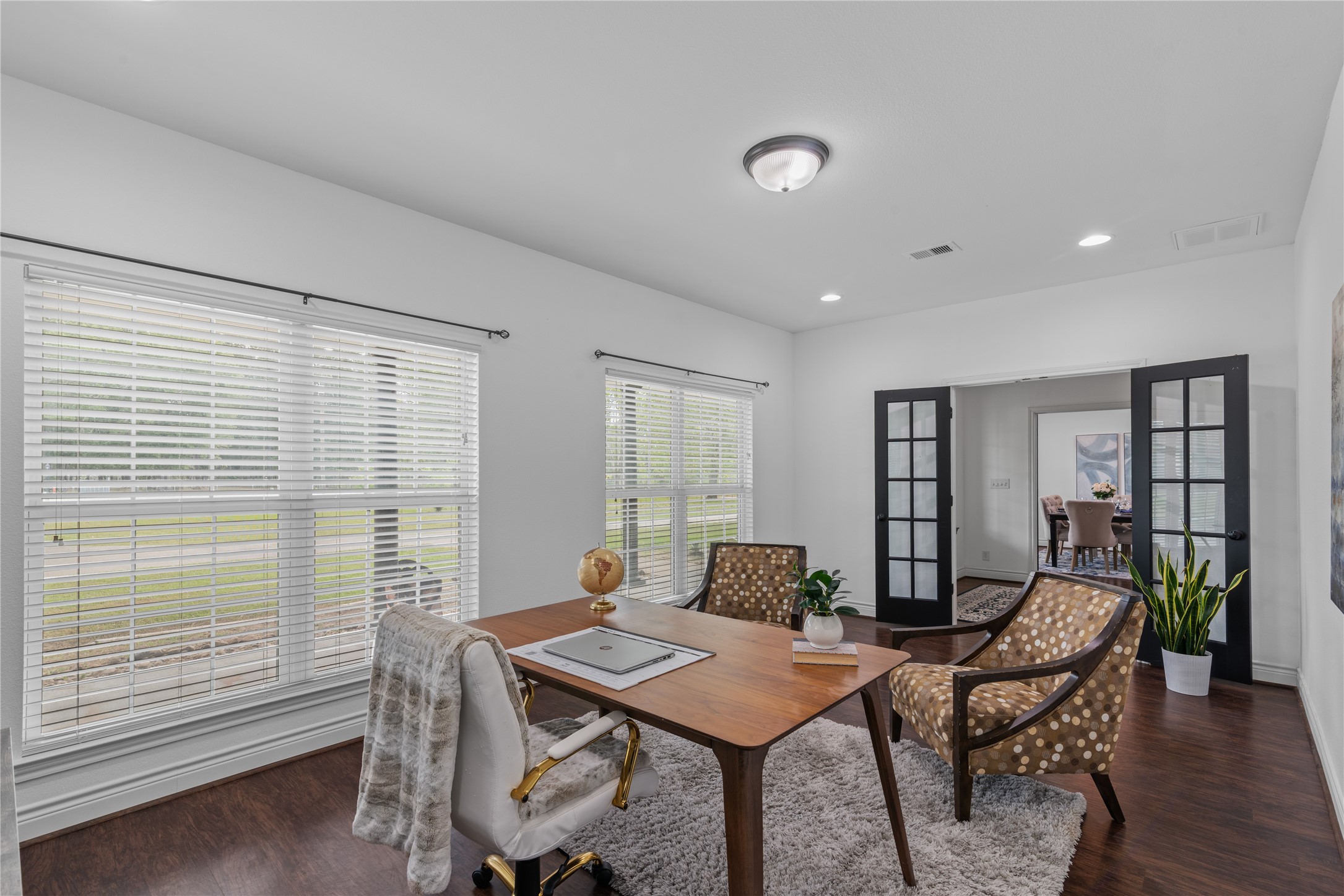 Black French doors add character to the home office and provide the option to close off the space for added privacy while working or studying.