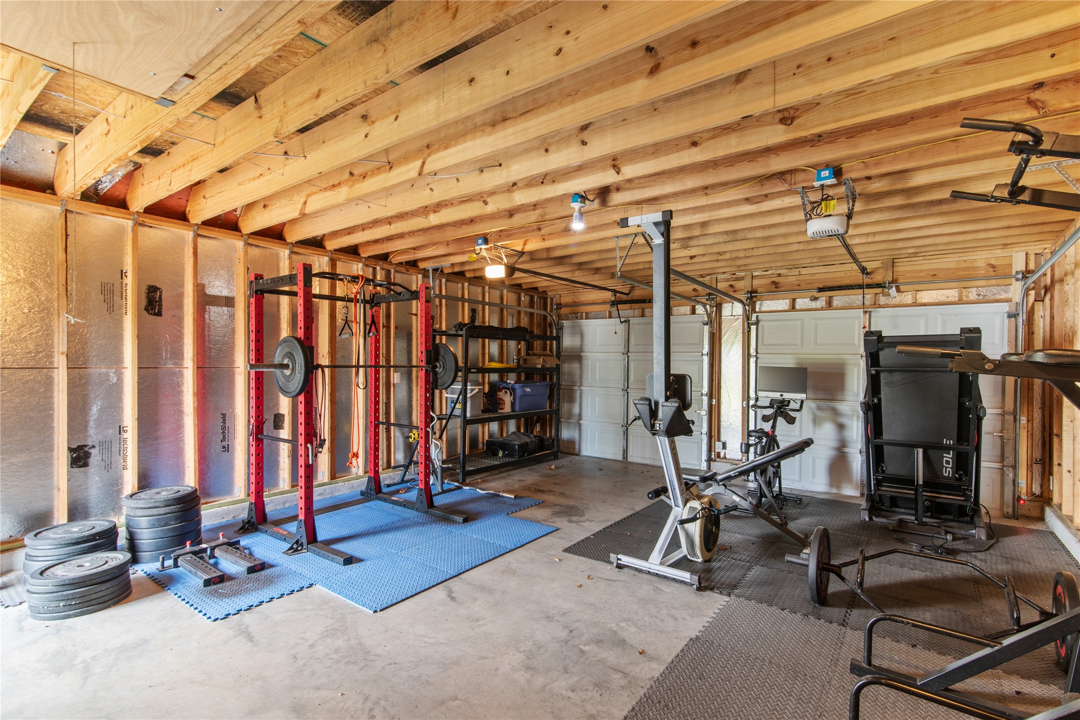 Detached two-car garage currently used as a home gym, offering flexible space for fitness, hobbies, or vehicle parking.