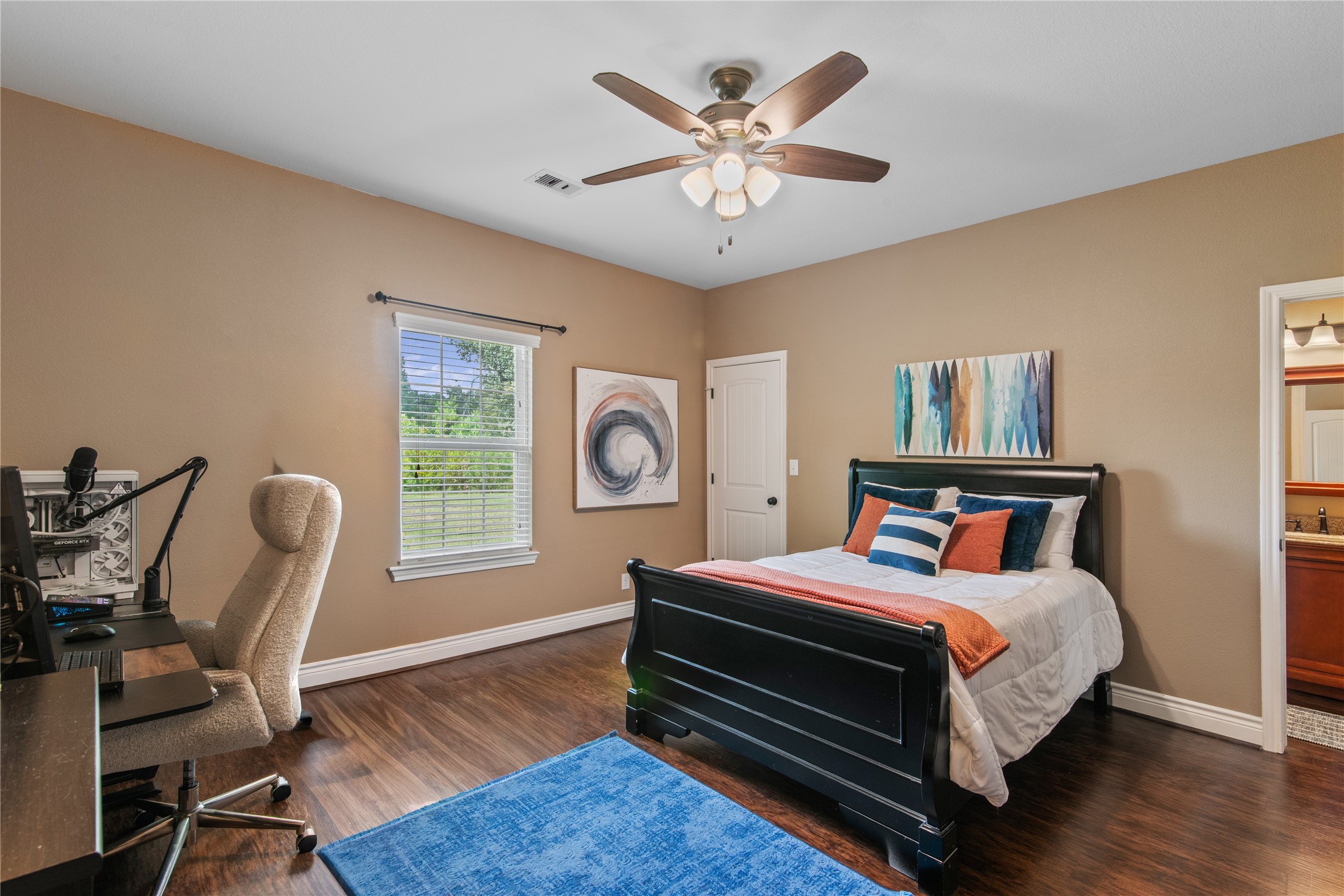 Spacious secondary bedroom with a walk-in closet, room for a desk, and direct access to the Jack-and-Jill bathroom shared with the adjoining bedroom.