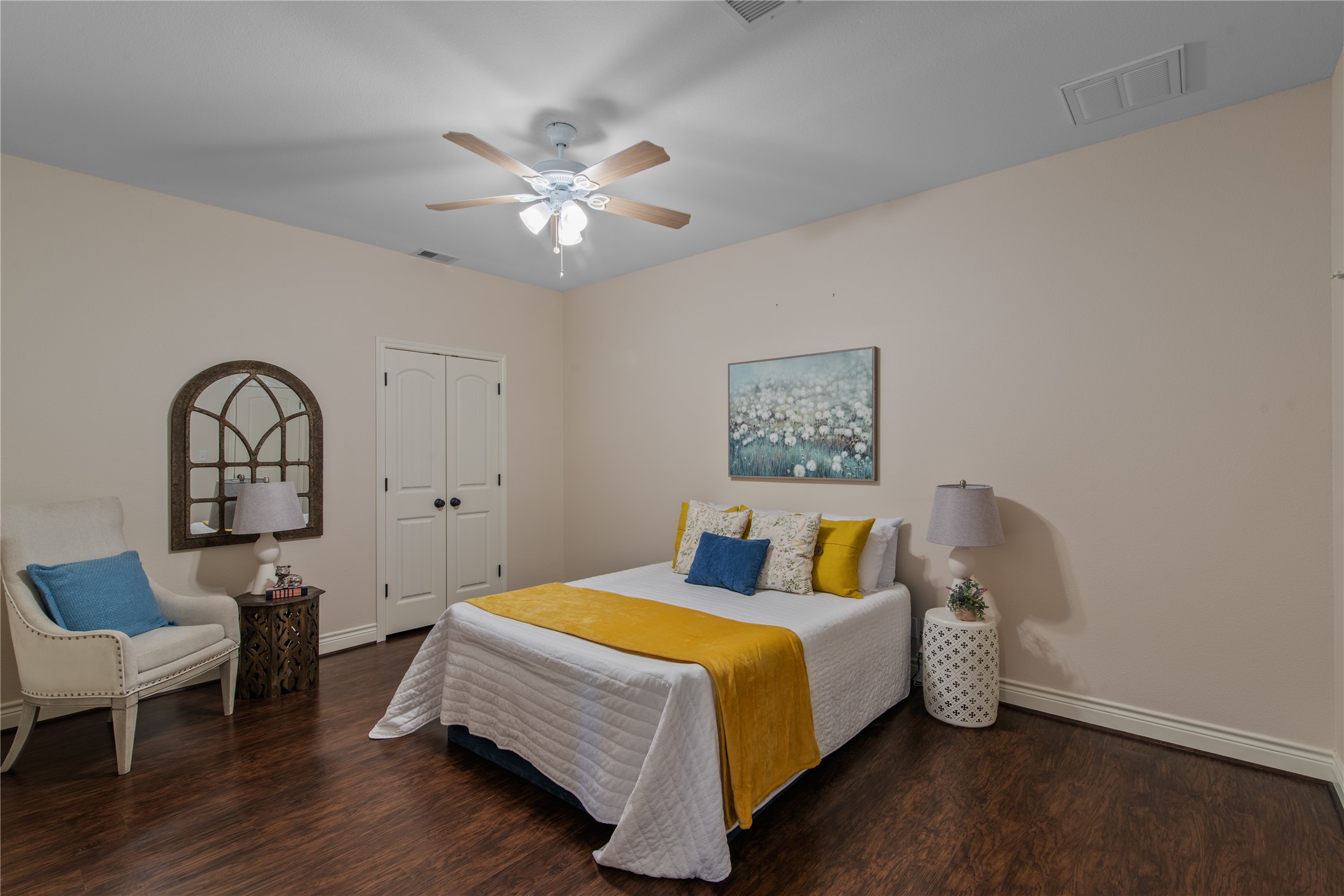 Additional flex room with high ceilings, wood-look flooring, and two closets. Currently staged as a bedroom, this space offers versatility for hobbies, exercise, or a home office.