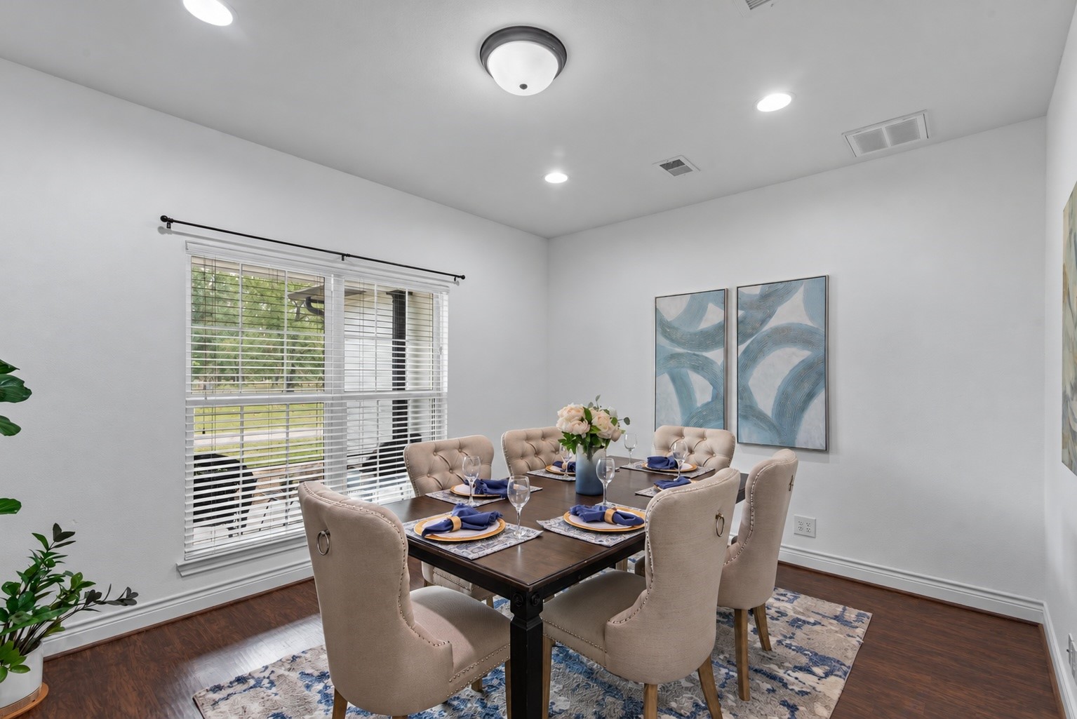 Versatile room currently staged as a formal dining area, with space to gather for meals and the flexibility to serve as a second home office.