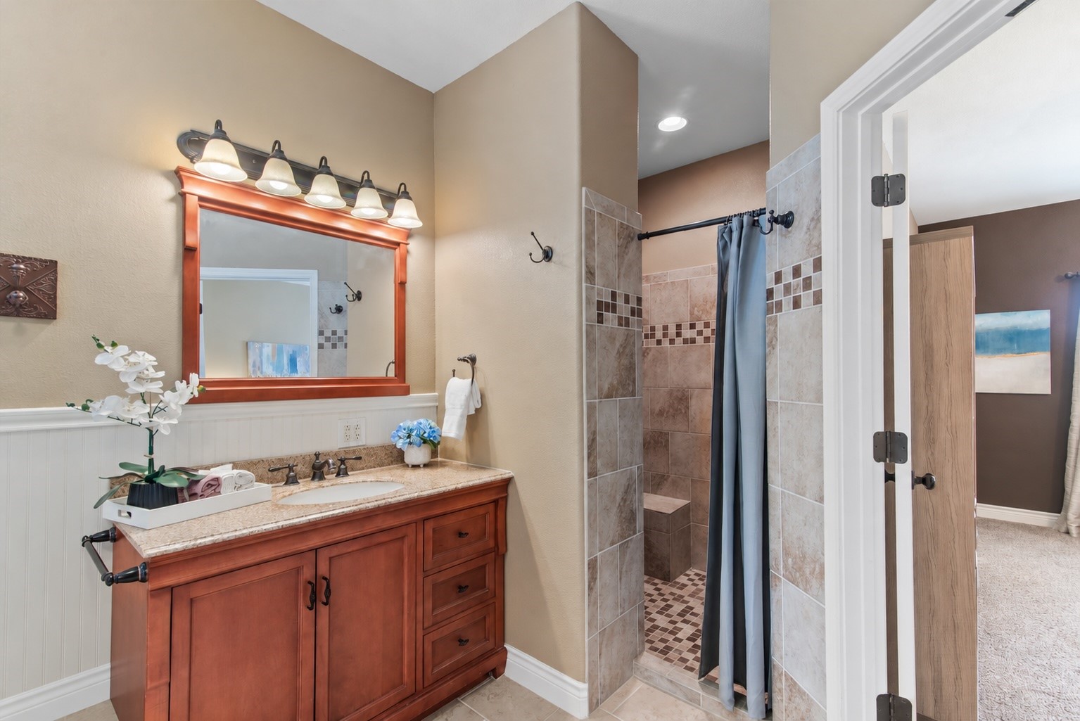A separate tiled shower and private toilet area add convenience to the thoughtfully arranged primary bath.
