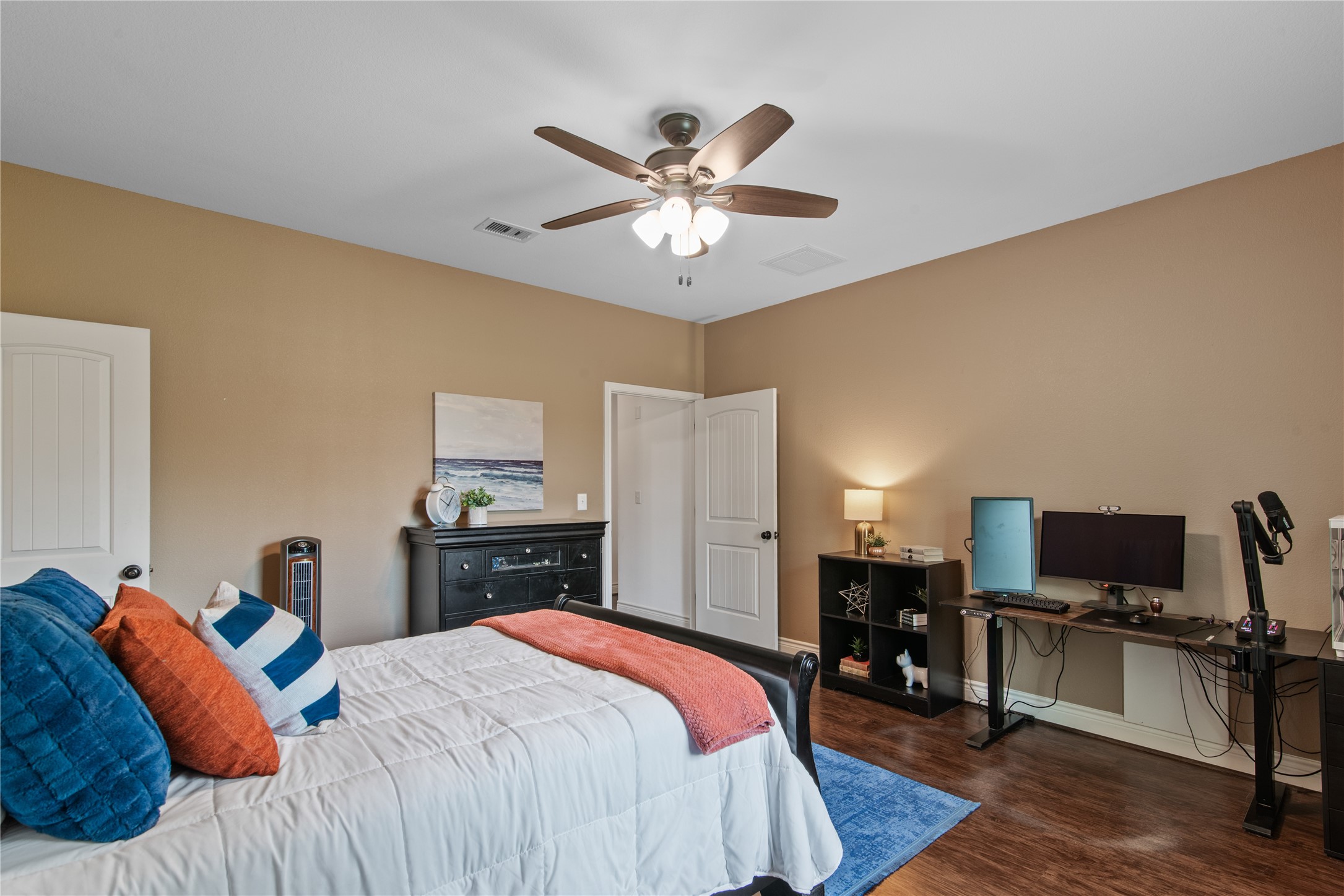 An alternate view highlights the bedrooms generous layout, with space for a dedicated workstation and additional furniture.