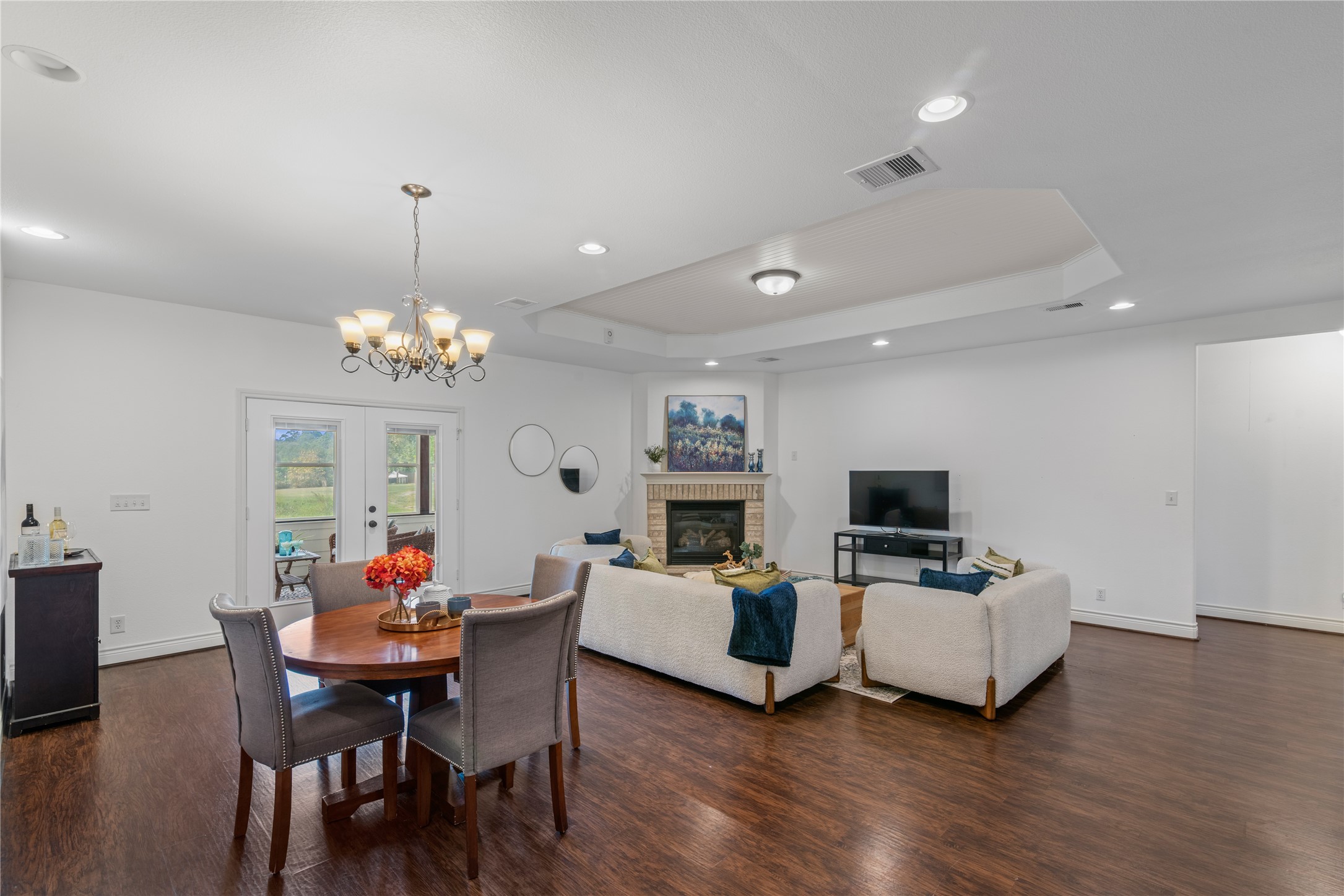 The open layout connects the breakfast area and family room, with double glass doors leading to the sunroom for additional space to relax and entertain.