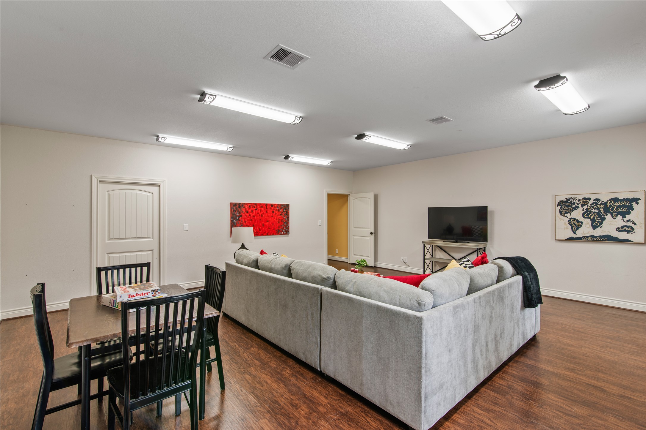 An additional view highlights the fourth bedrooms generous proportions, with room for separate seating and game-table areas.