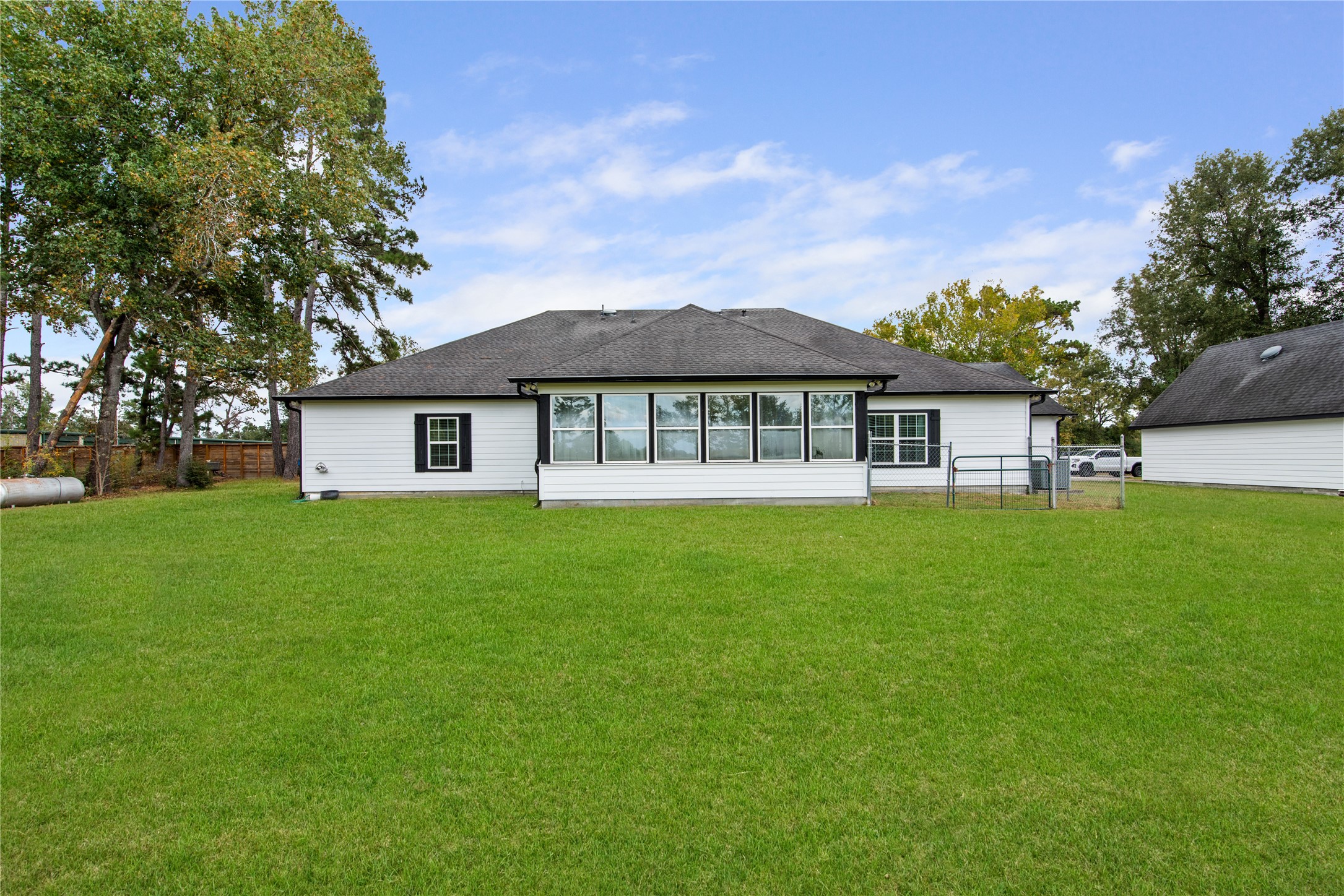 A dedicated pet run provides a separate outdoor space for pets, adding convenience to the spacious backyard.