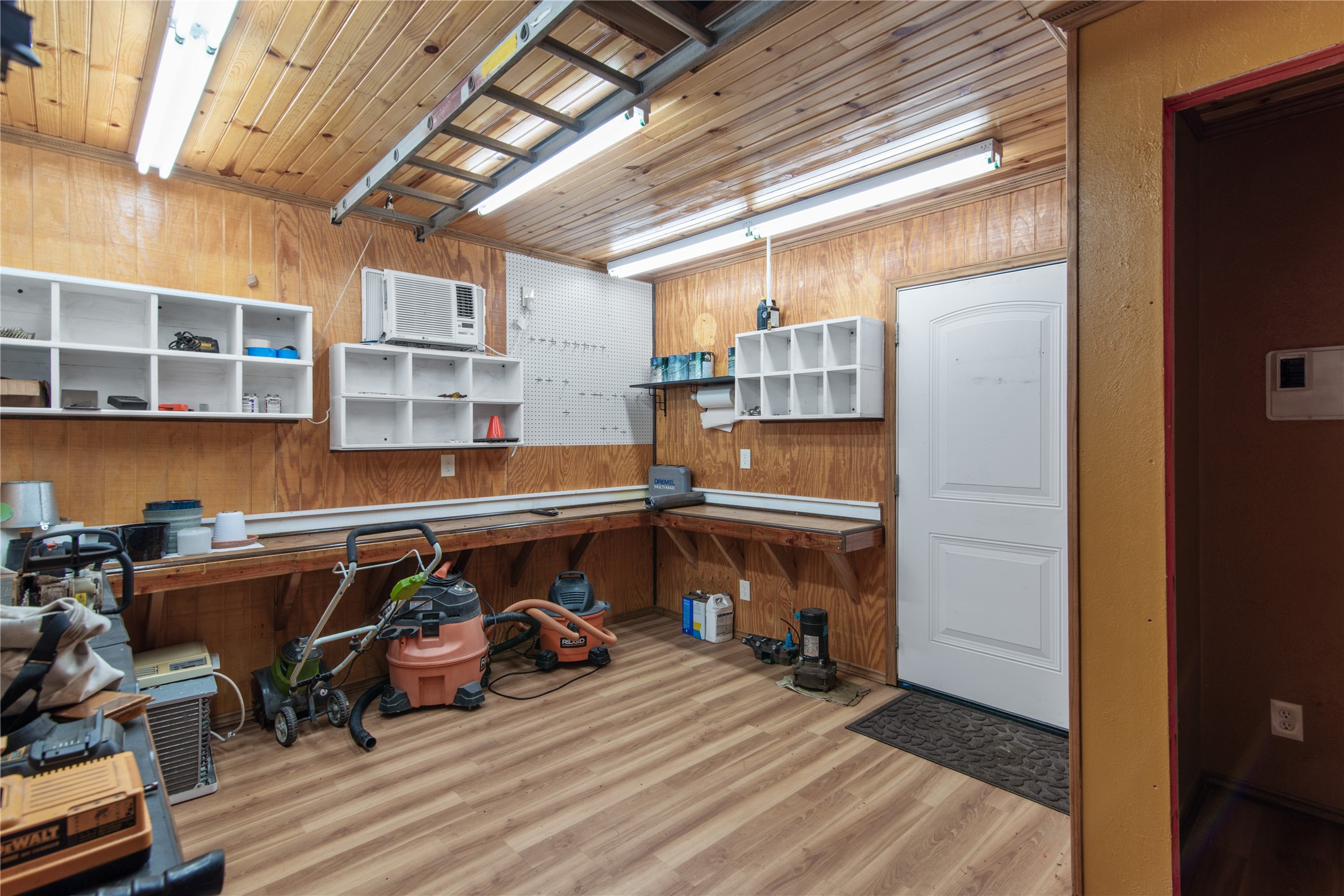 The 15'  11' workshop features A/C, built-in workbenches, shelving, and attic storageideal for hobbies and projects.