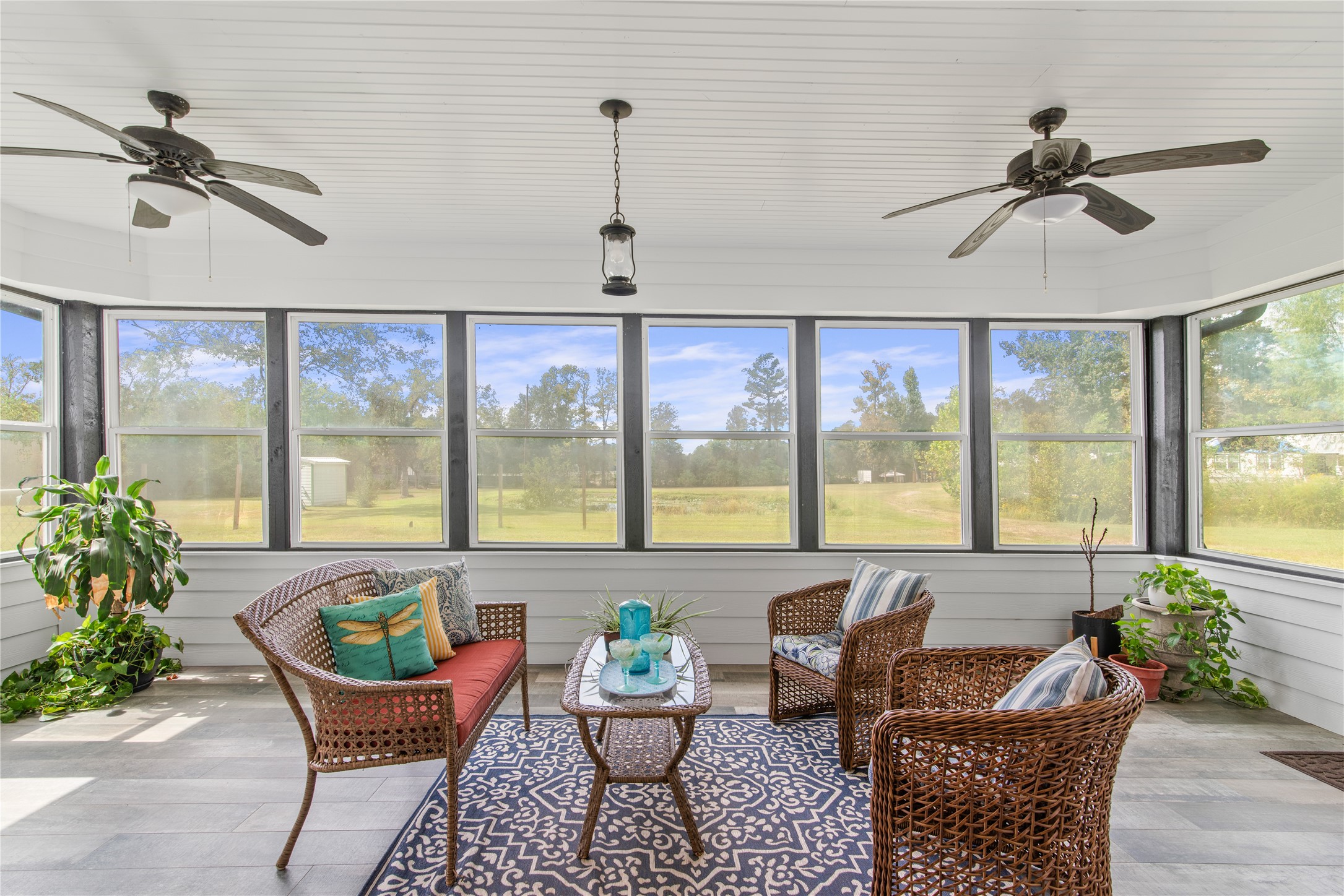 Sunroom conveniently located off the family room and breakfast area, with two exterior doors providing easy access to the backyard.
