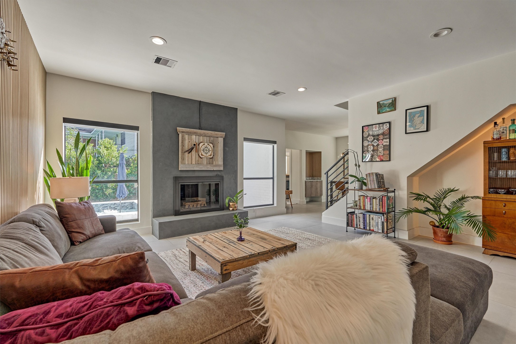 This reimagined den offers a cozy corner in which to relax or entertain around the fireplace.