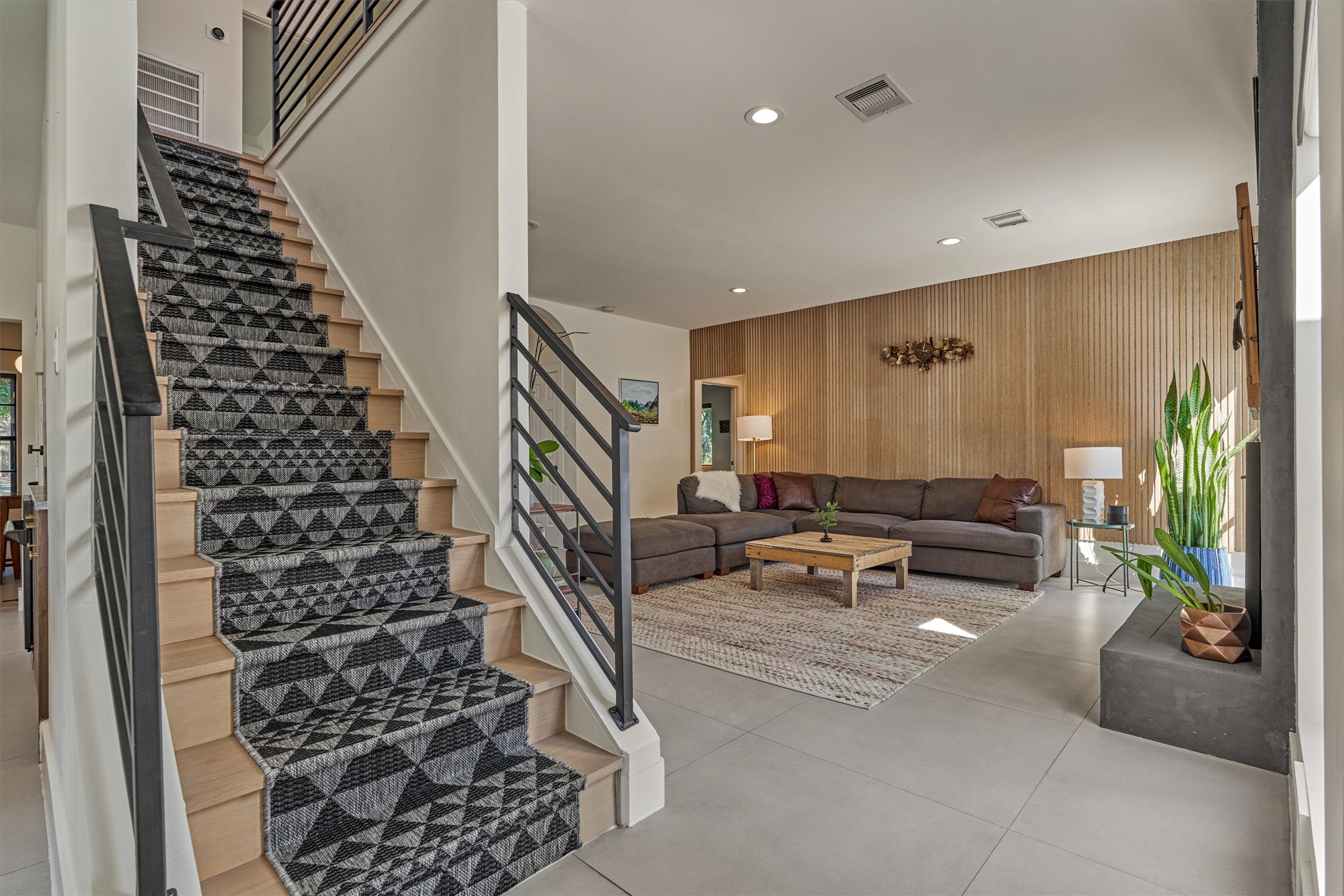 Your eye will be drawn to the lighted stairwell with custom runner that continues the light/dark design as we head upstairs.