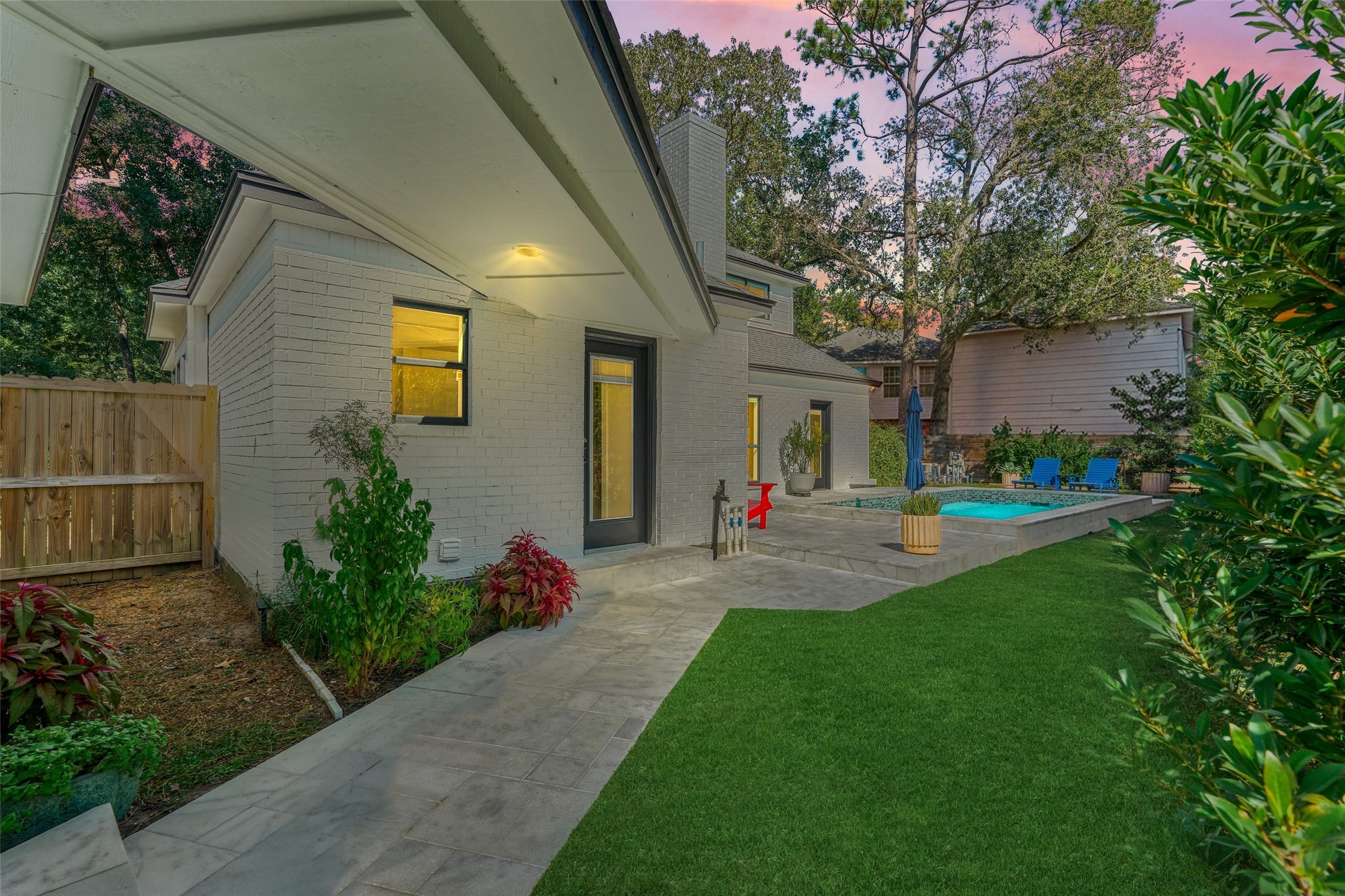 Covered walkway connects the backyard to the detached garage for protection from the elements. Sellers have added a new electrical panel and generator hook up here for added convenience.