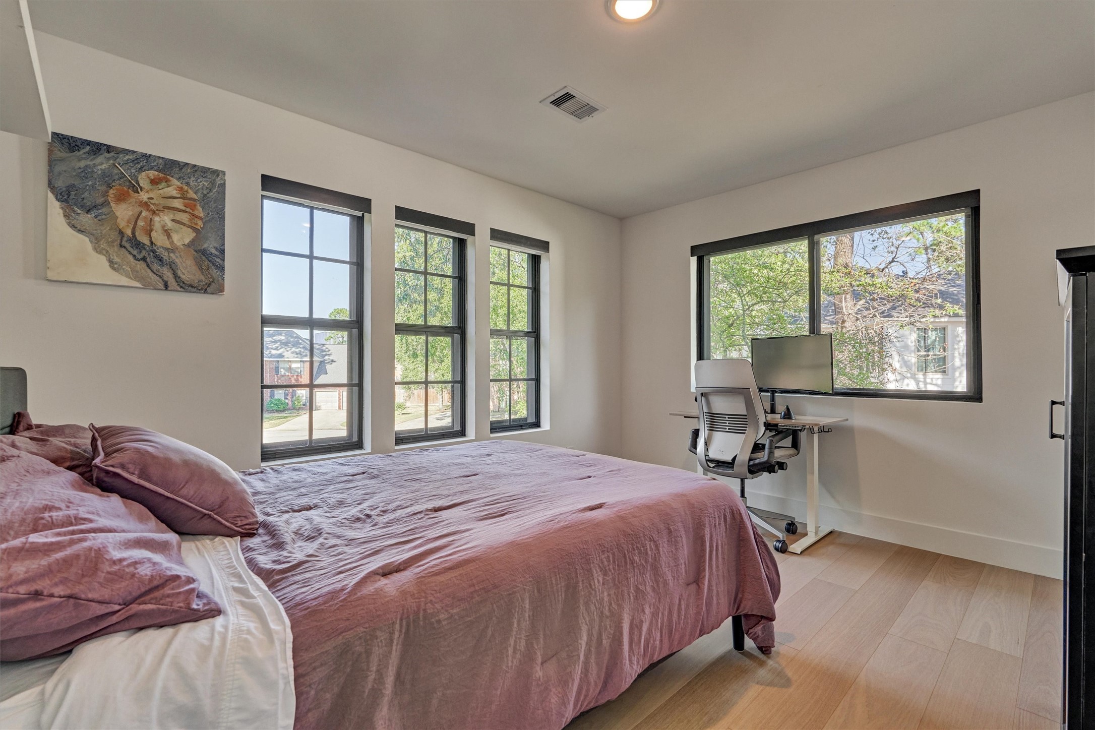Bedroom 3 is generous in size and features white oak flooring and corner views, with custom shades on all windows. No carpet here is ideal for those with allergies!