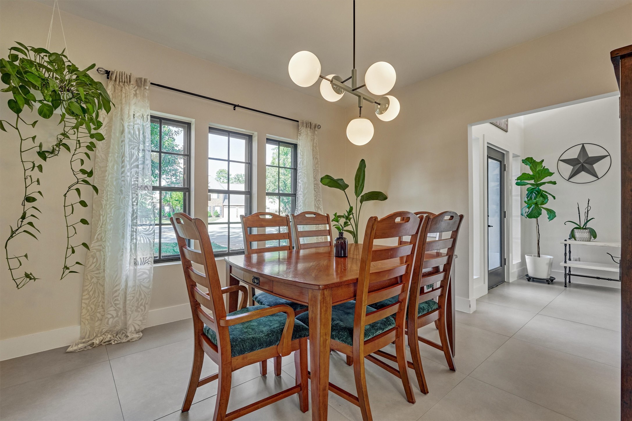 Stately dining room with designer-inspired chandelier is flooded with natural light!