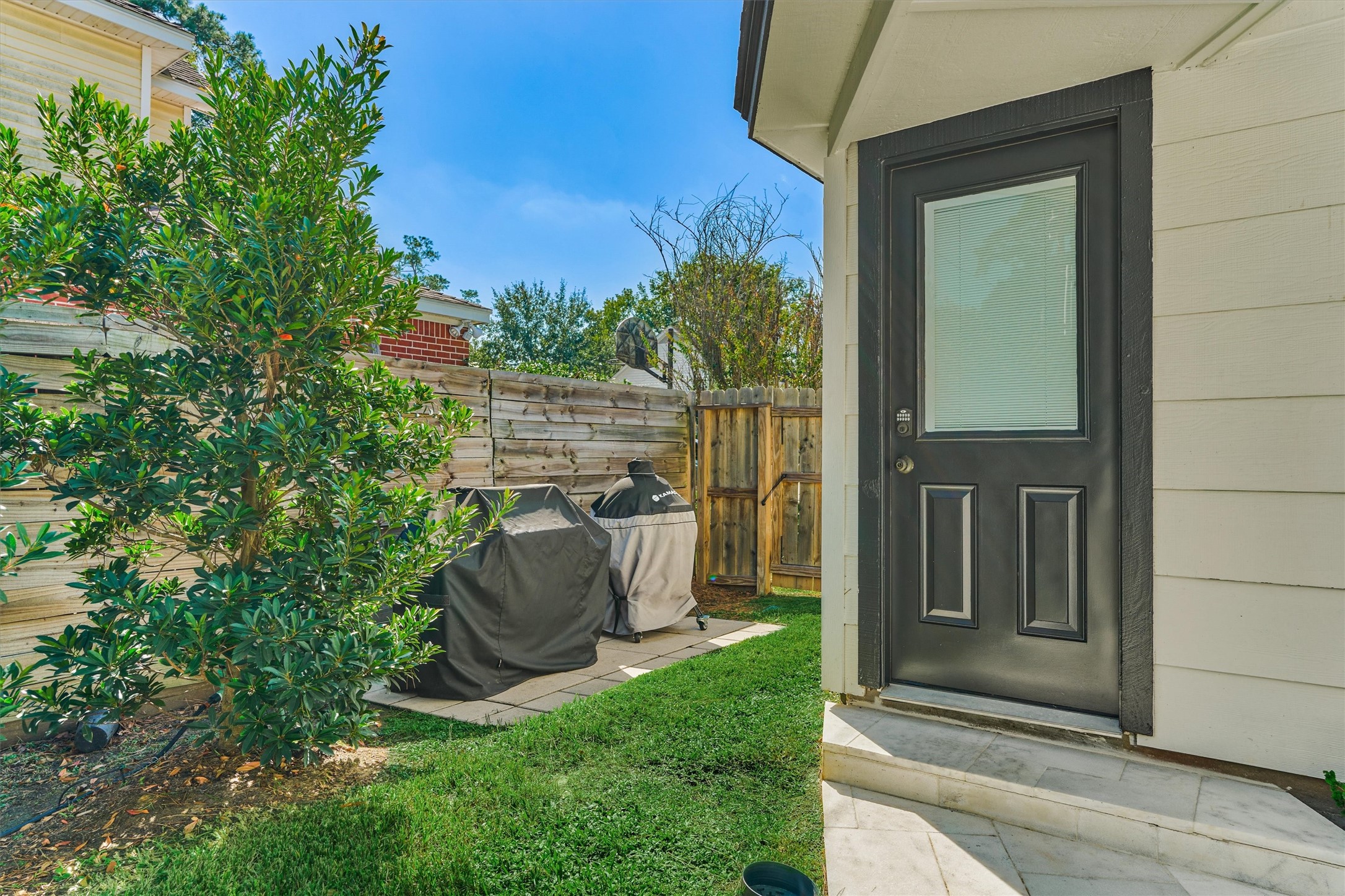 Improved BBQ pad sits just off the rear of the detached garage to make grilling a breeze!