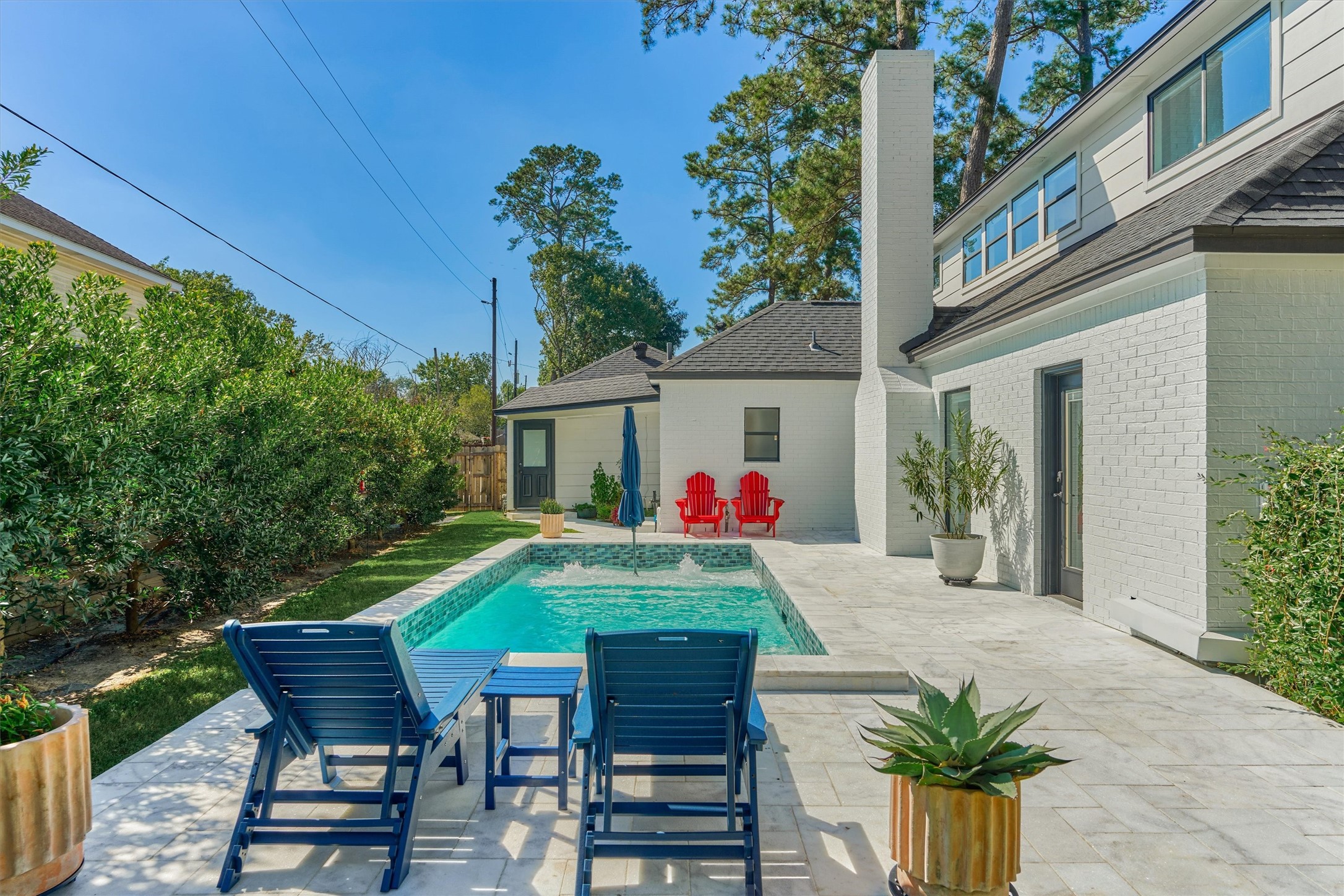 Recently painted exterior shines bright alongside the Travertine decking!