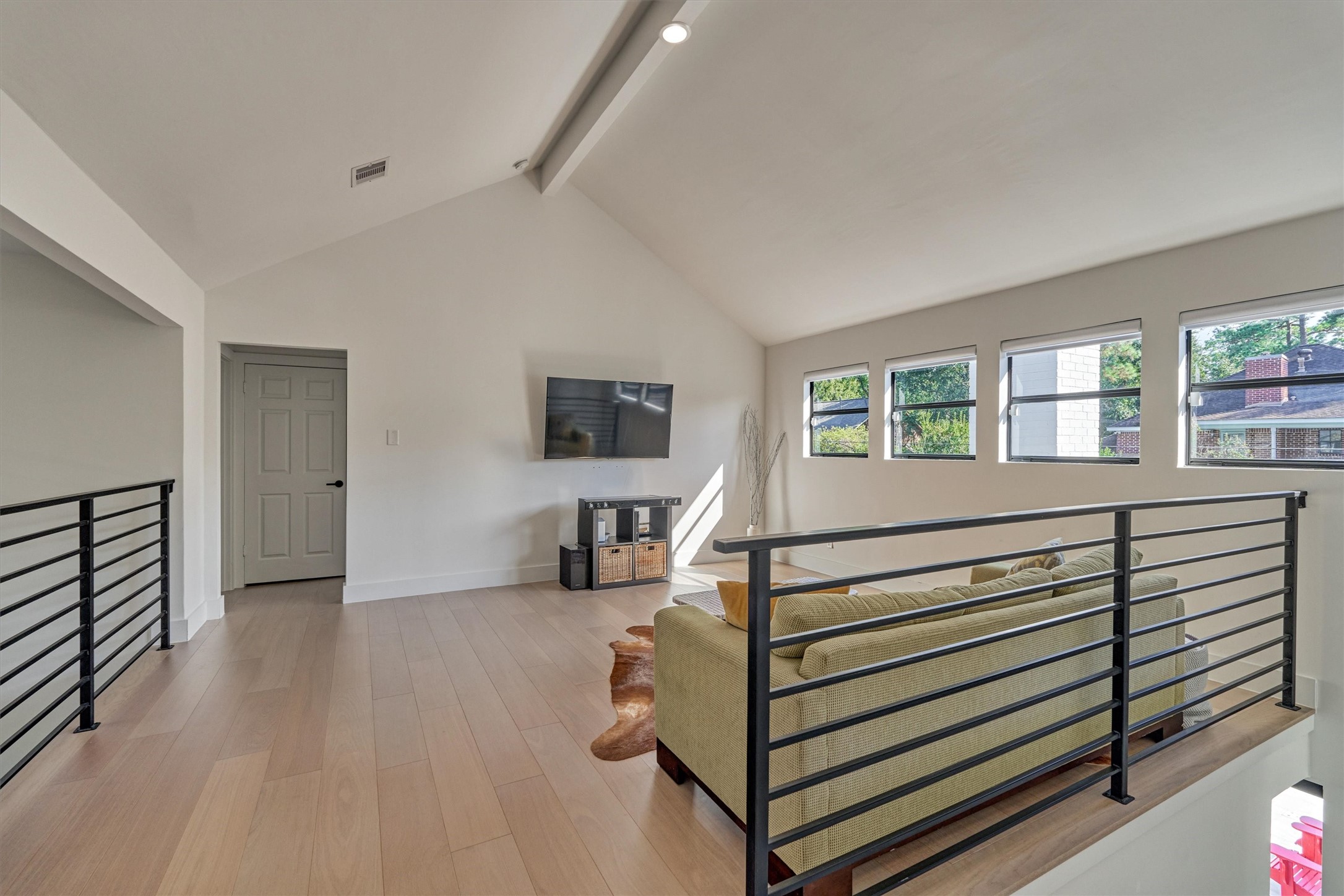 Second floor game room with wrought iron railing detail and LED lighting (throughout) is the ideal flex room!