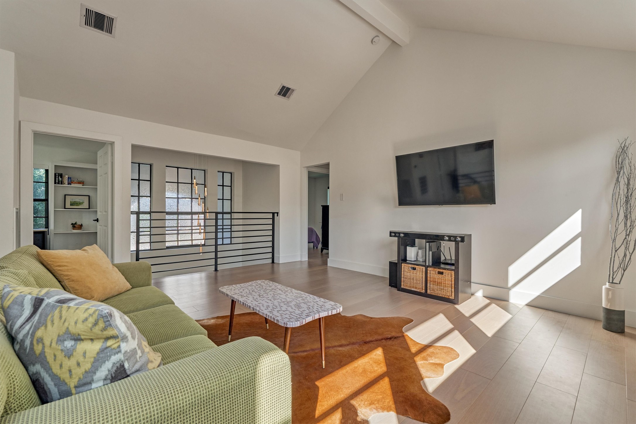 This flex space with vaulted ceiling could easily serve as a game/media room, home gym, or office. Note the custom chandelier which hangs in the two-story foyer!