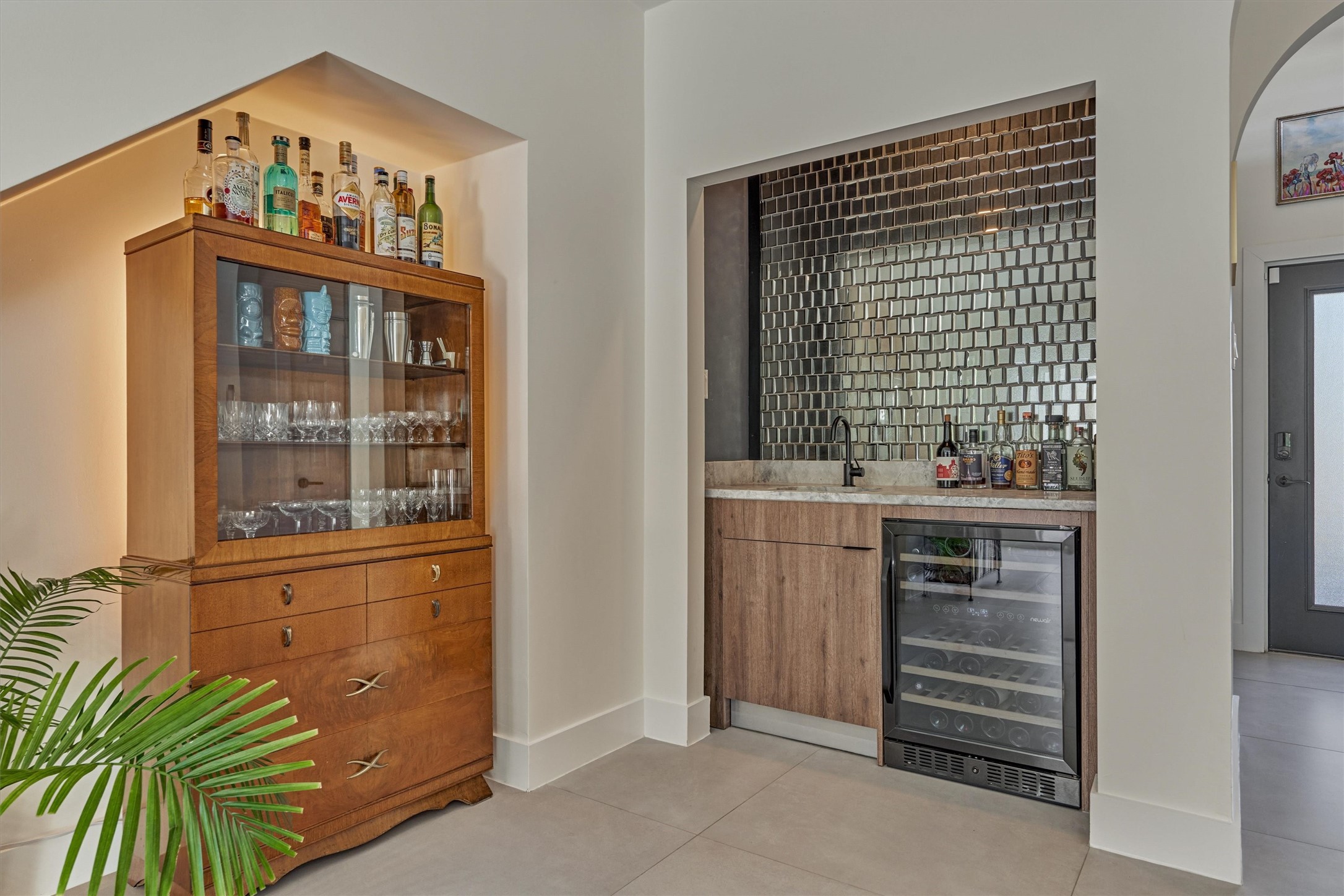 Every space has been maximized for use with smart storage solutions. Wet bar area in the den features built in dual zone wine chiller and striking glass tile backsplash.