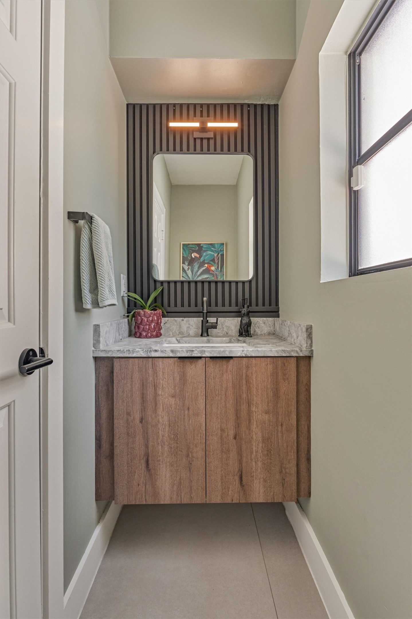 Powder bath aligns in style with the rest of the home.  Easily serves as a pool bath positioned near the back door/laundry area of the home.
