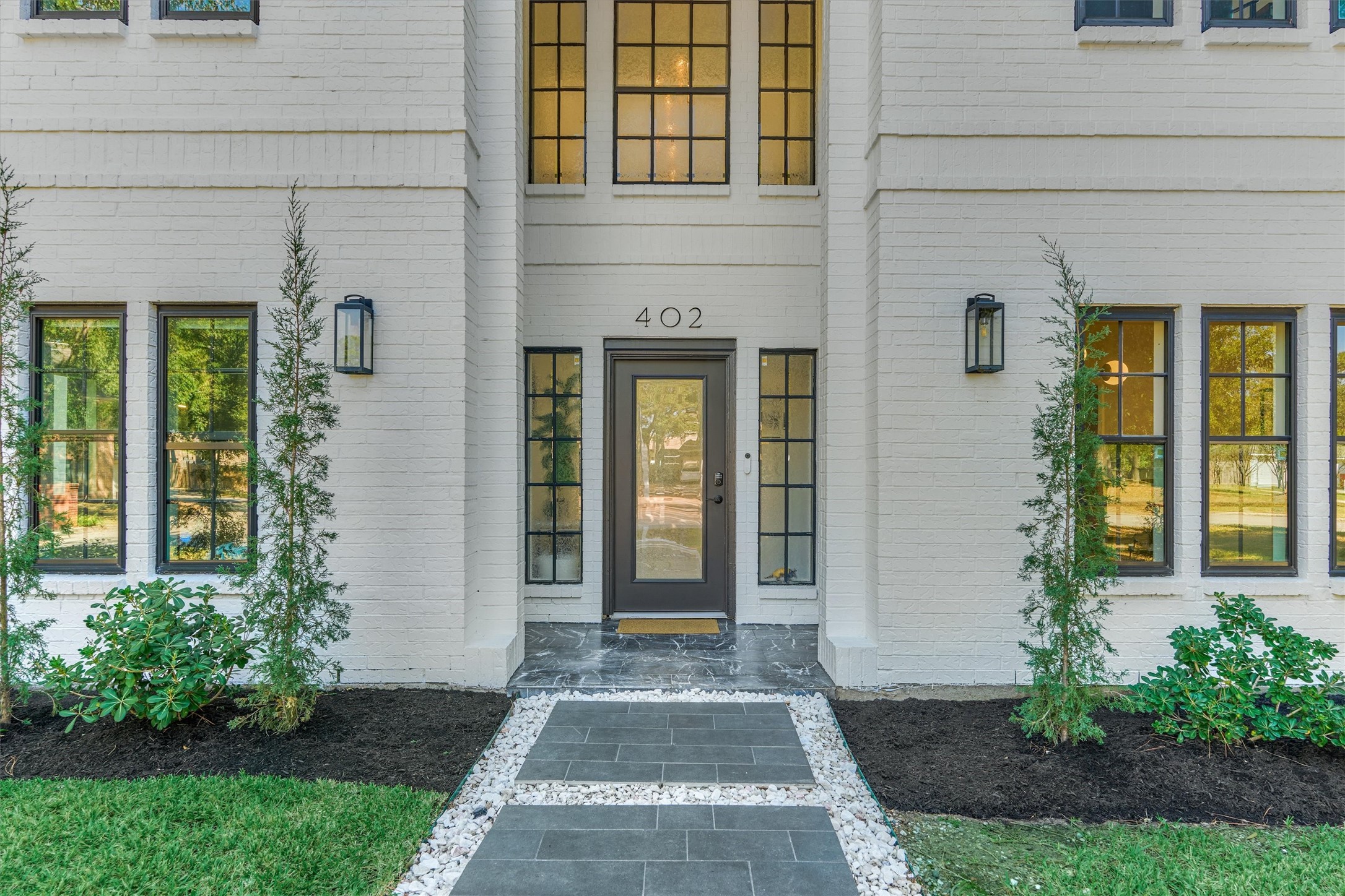 Stone walkway, black marble entry, and recent roof ('22) add to the extreme curb appeal of this home!
