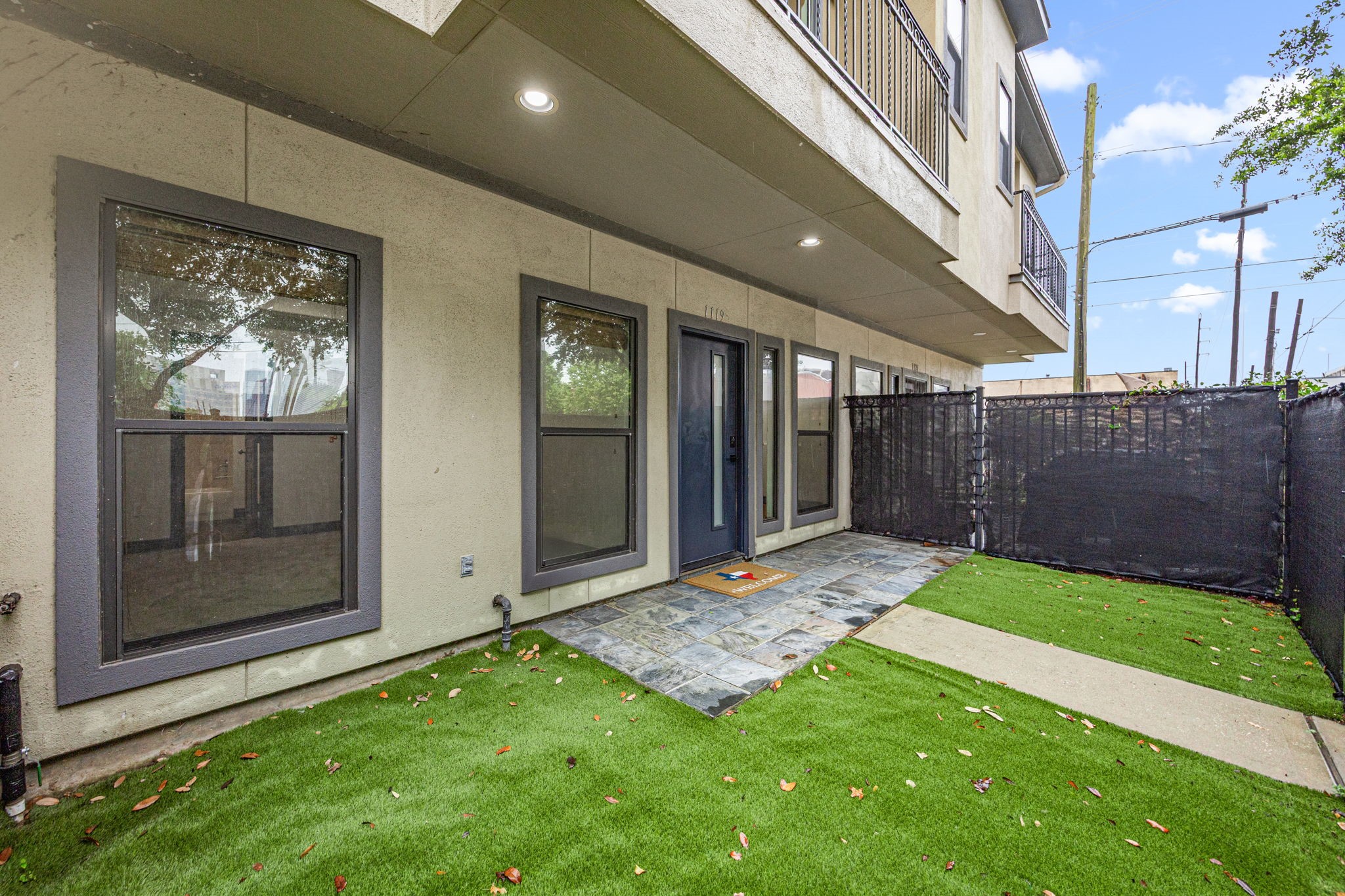 Front yard turfed with privacy screens