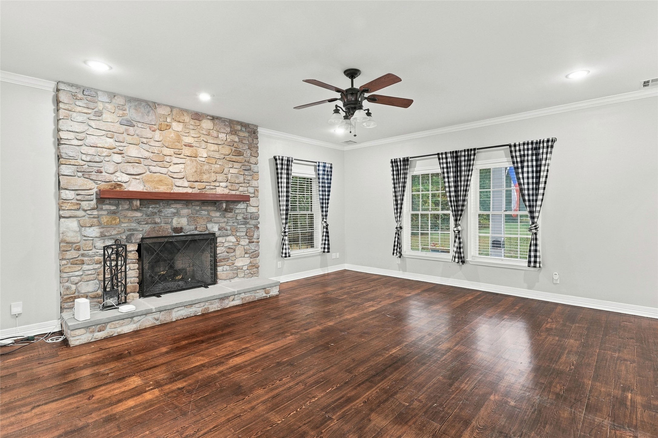 Check out this cozy family room centered around a stunning stone fireplace.