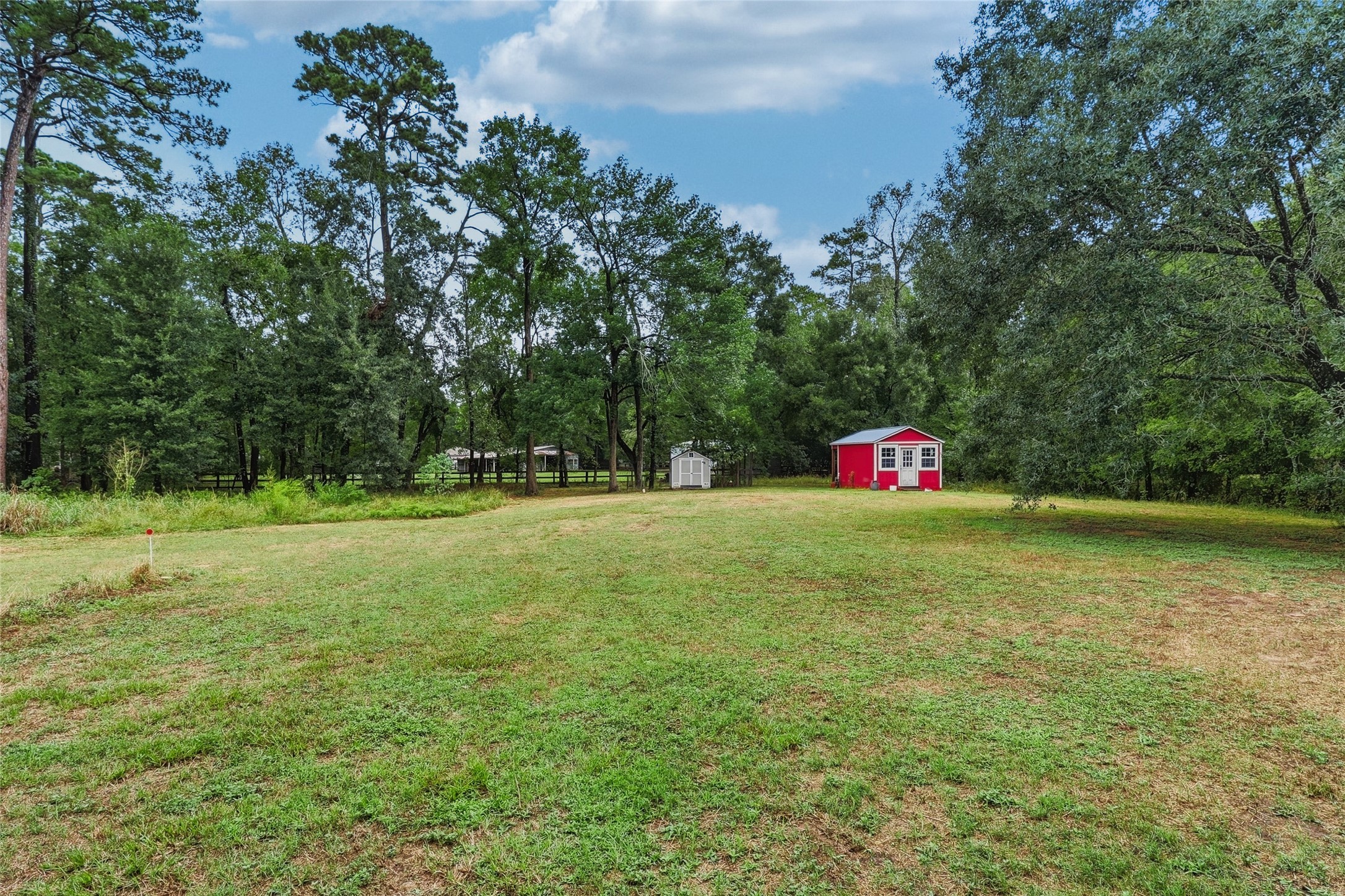 Overlooking the expansive backyard, complete with a functional chicken coop and powered red "she" shed.