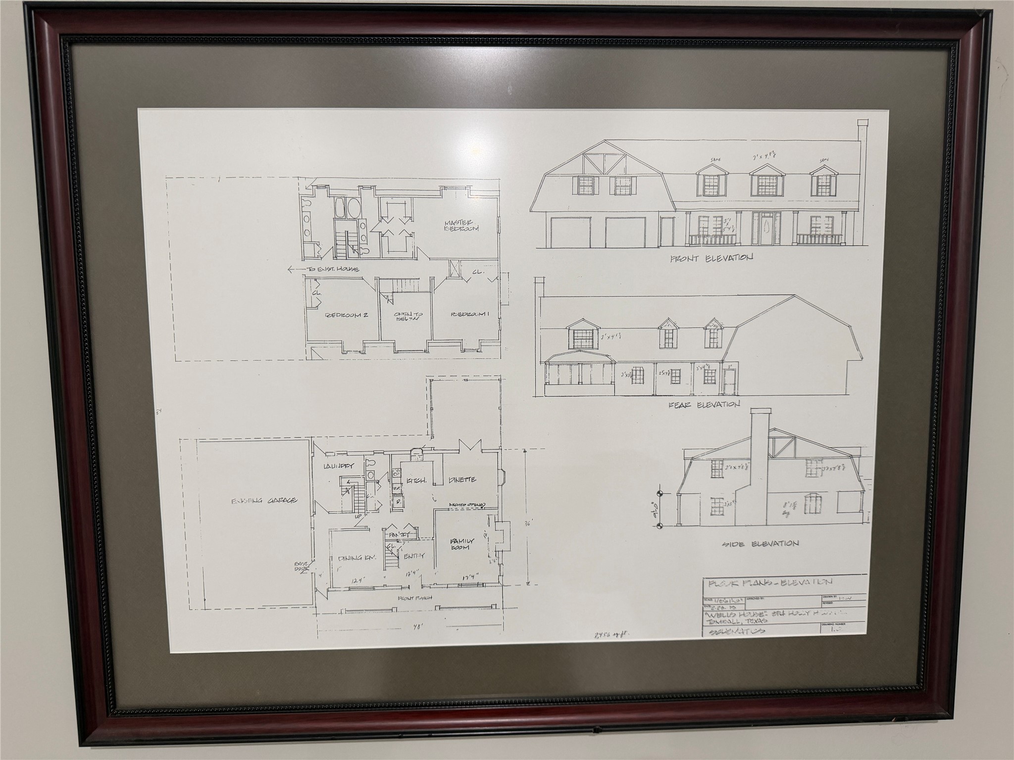 Framed architectural drawings showcasing the thoughtful design and layout of this custom build.