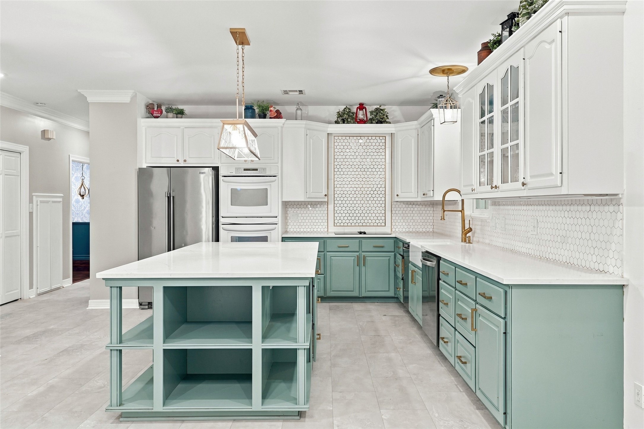 This stunning kitchen features a clean, modern aesthetic highlighted by elegant two-tone cabinetry, durable granite countertops, and a beautifully coordinated backsplash.