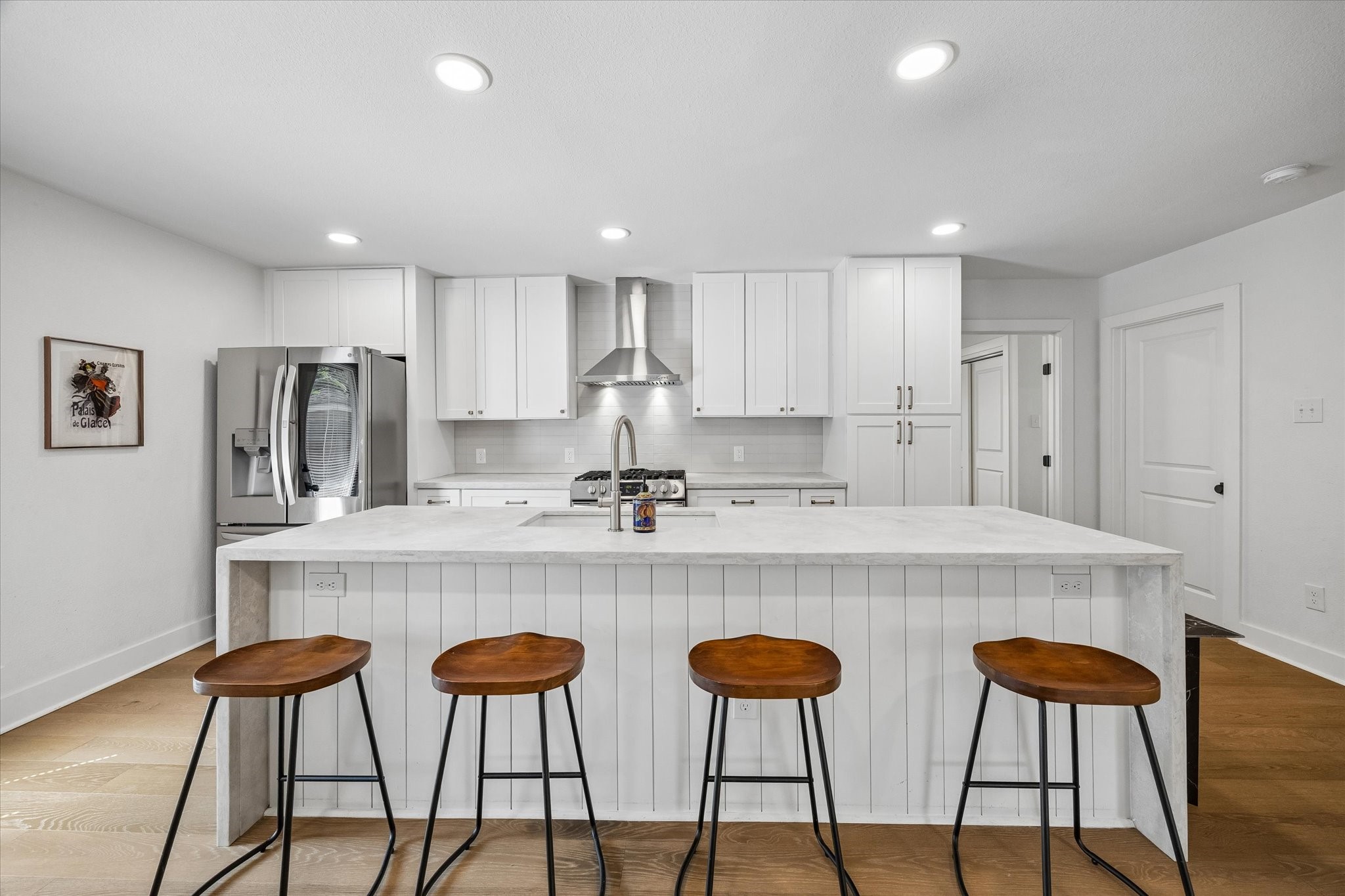 Designed to be the heart of the home, the kitchen centers around an oversized waterfall island with seating for four, abundant cabinetry and a clean, contemporary palette.