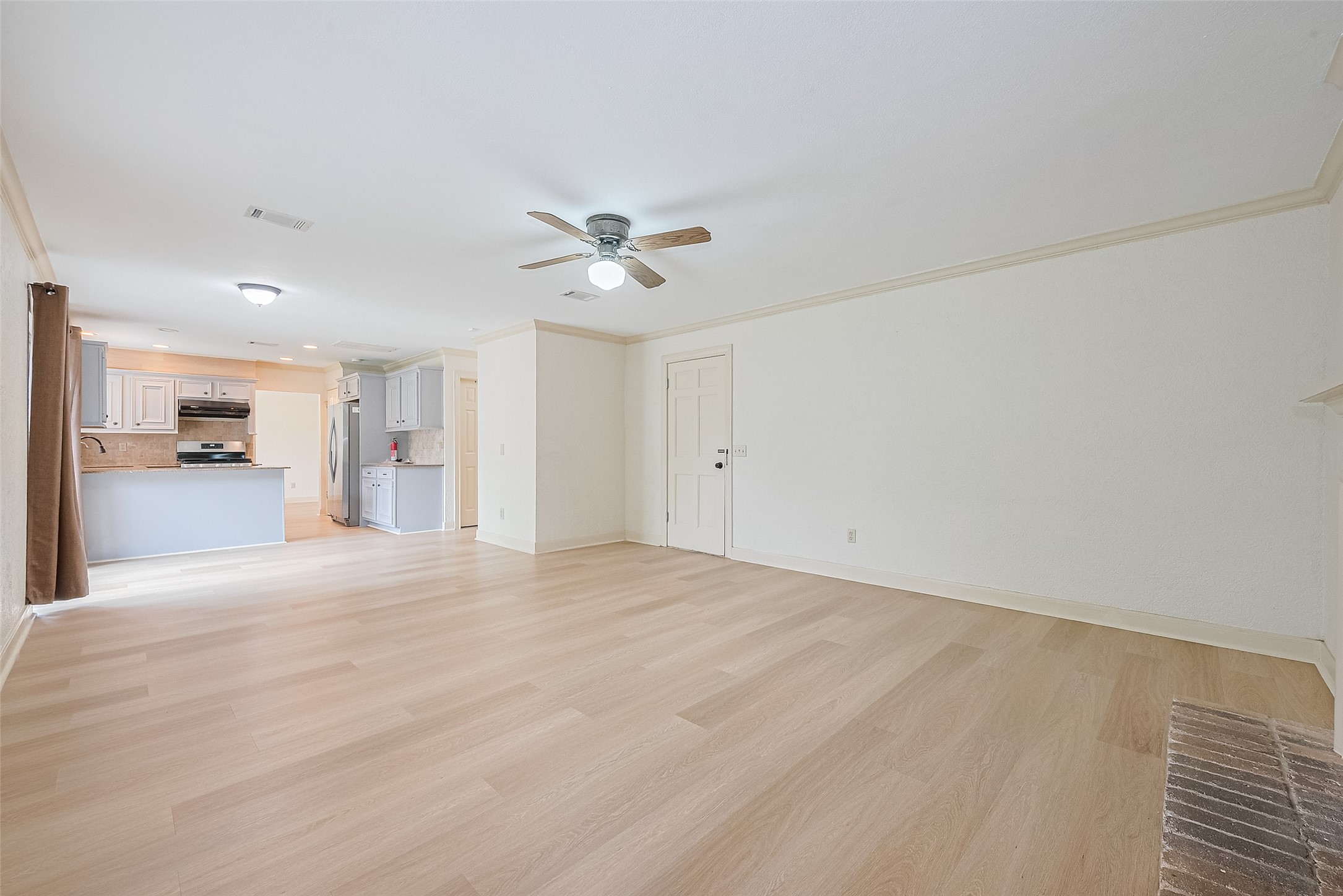 Living room opening to granite kitchen