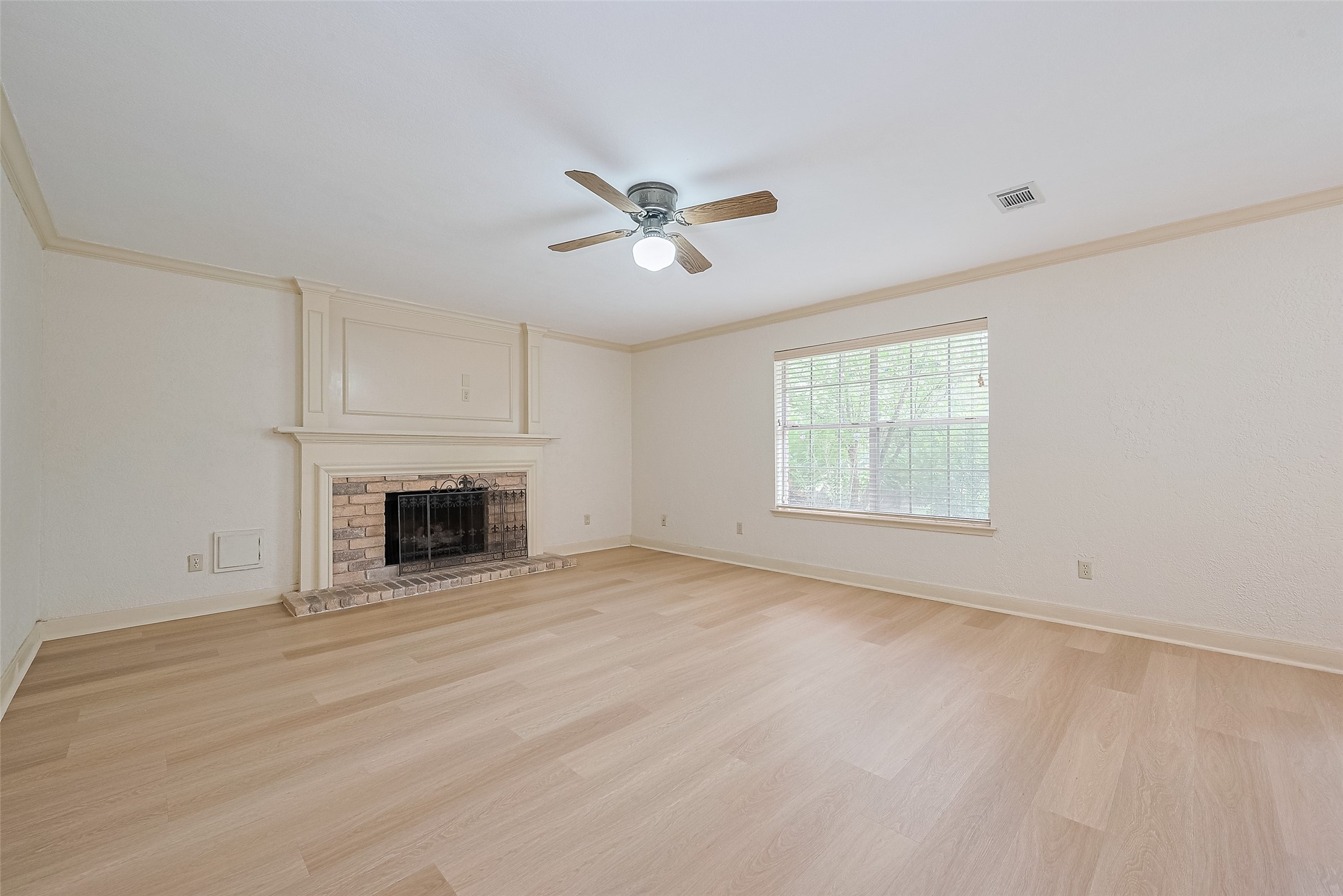 Formal living with fireplace and ceiling fan