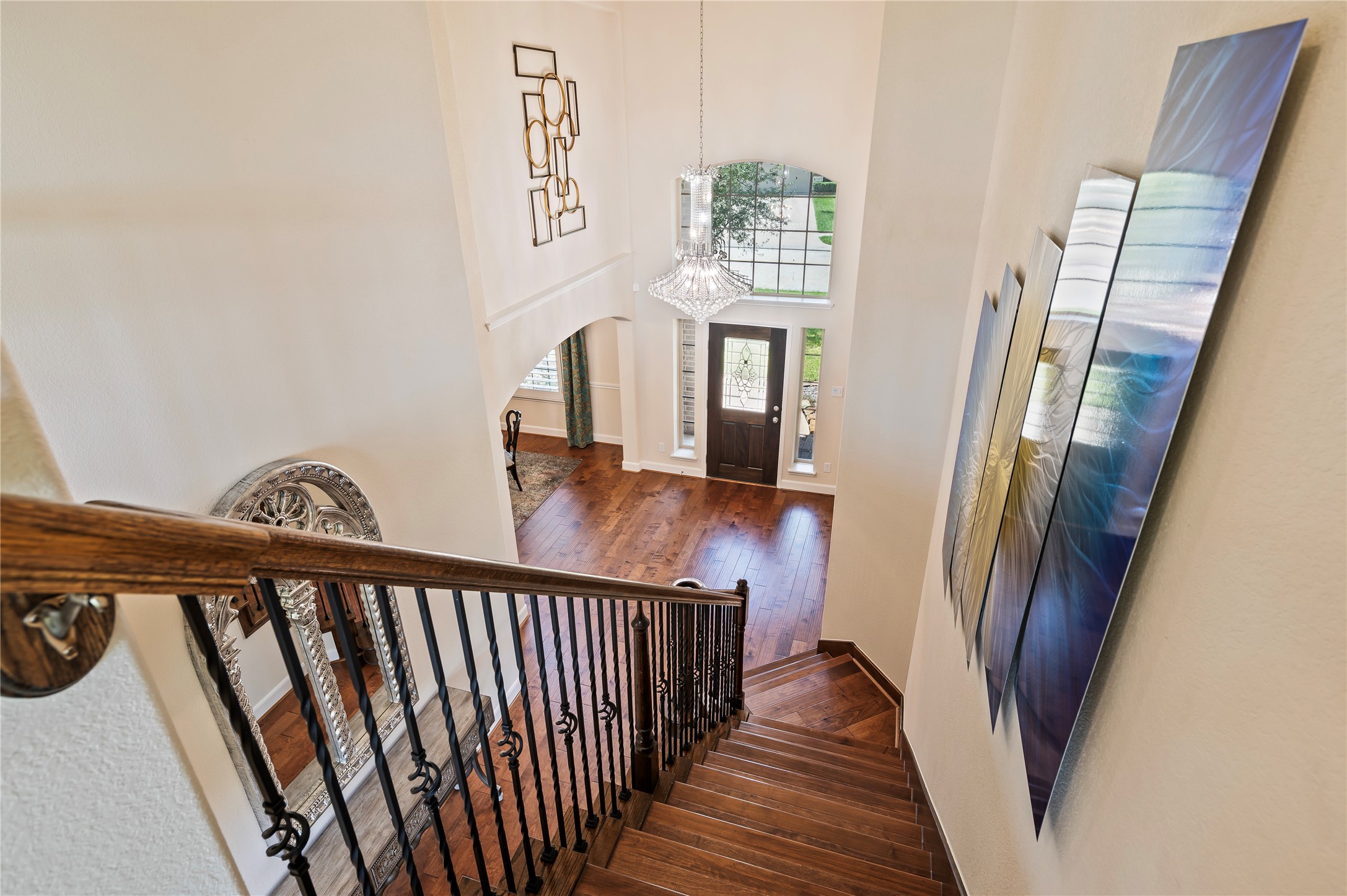 Hardwood floors grace the stairway leading to the 2nd level featuring wrought iron spinals,