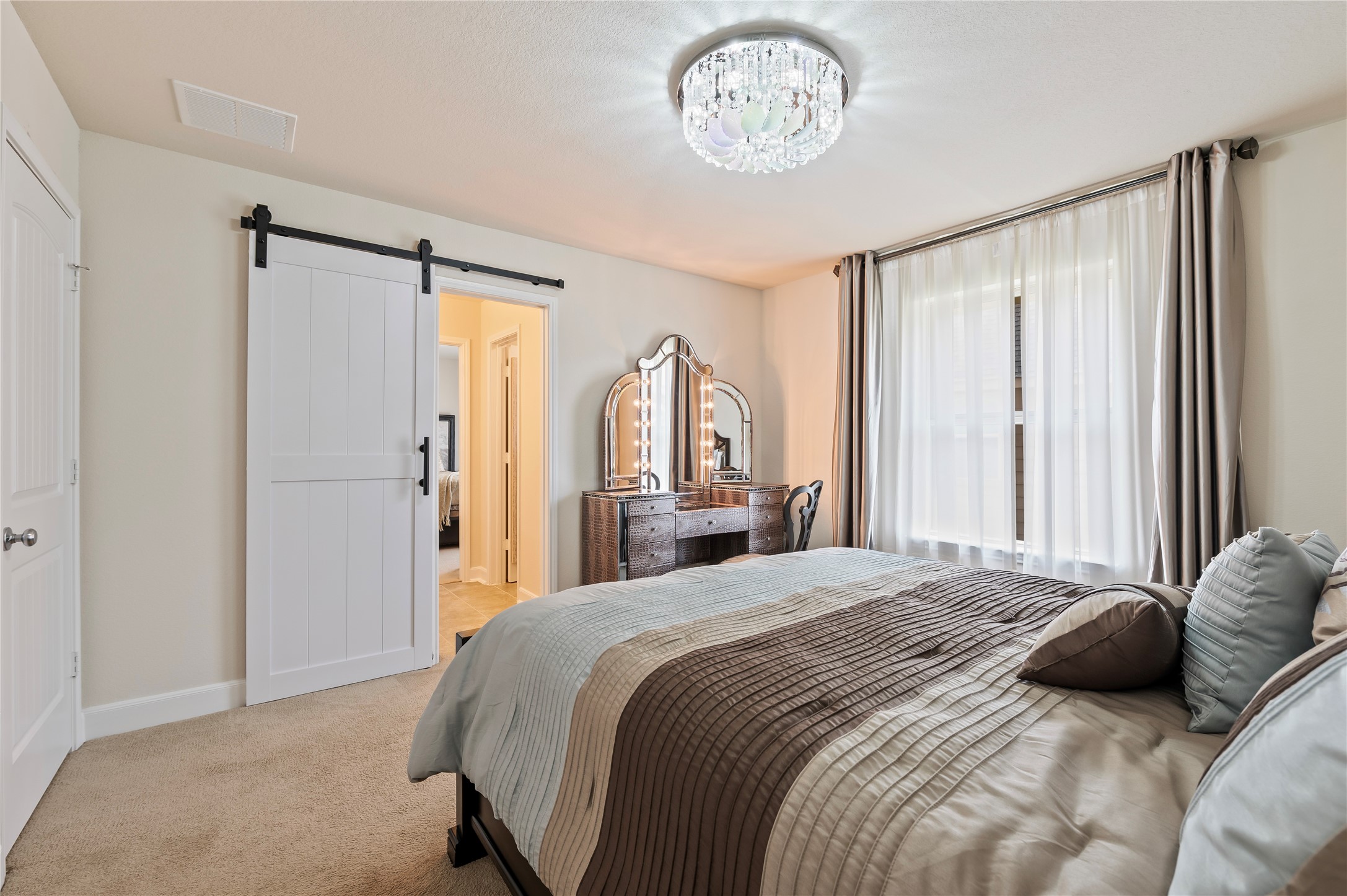 4th bedroom upstairs with custom light fixtures, walk-in closet and custom sliding barn doors leading to Jack-n-Jill bathroom.