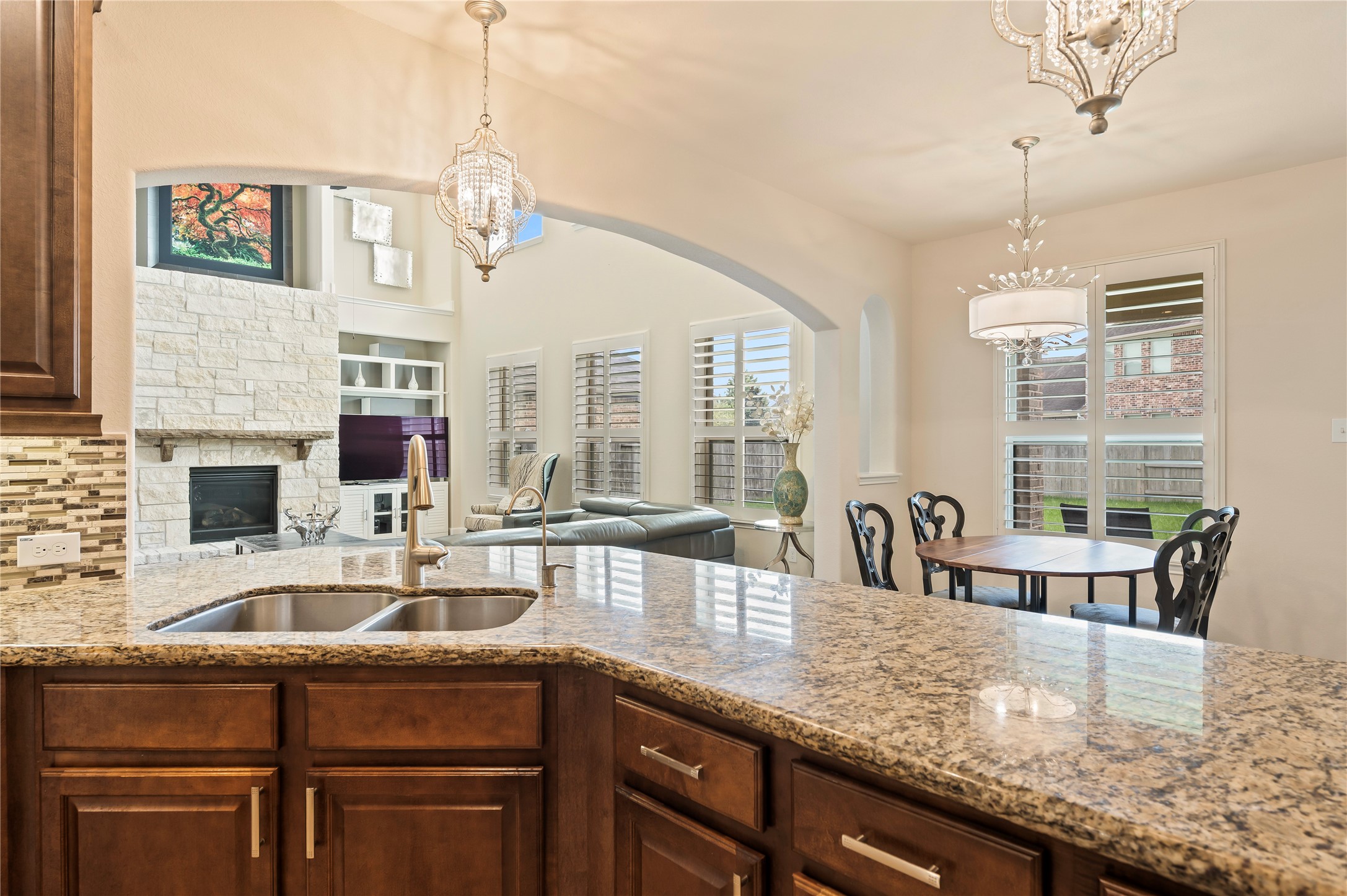 Double stainless steel sink with pull-out faucet and reverse osmosis filtration system compliments the wrap-around breakfast bar.