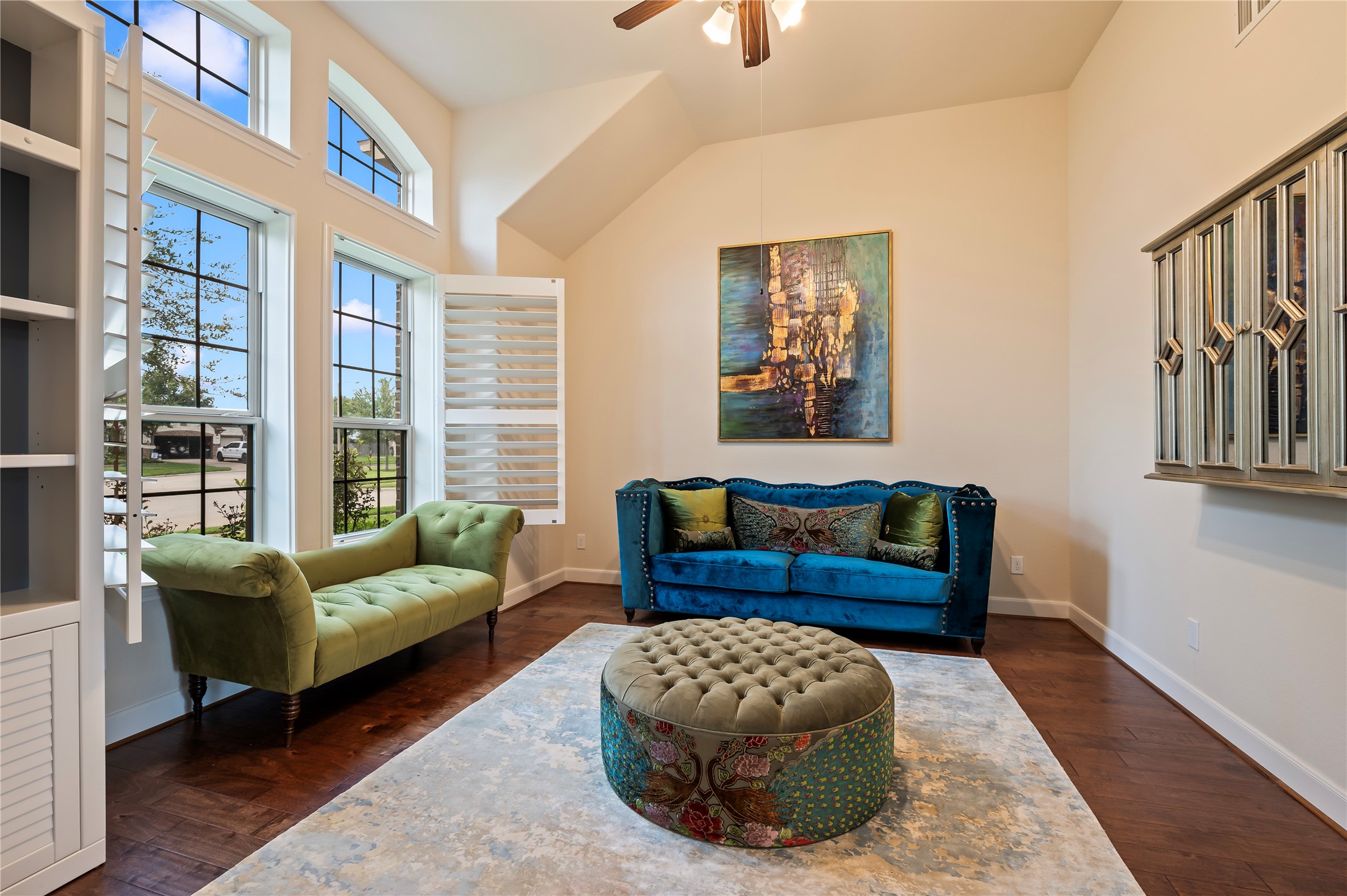 Another view of the private home-office with freshly painted neutral paint tones, plantation shutters and ceiling fan.
