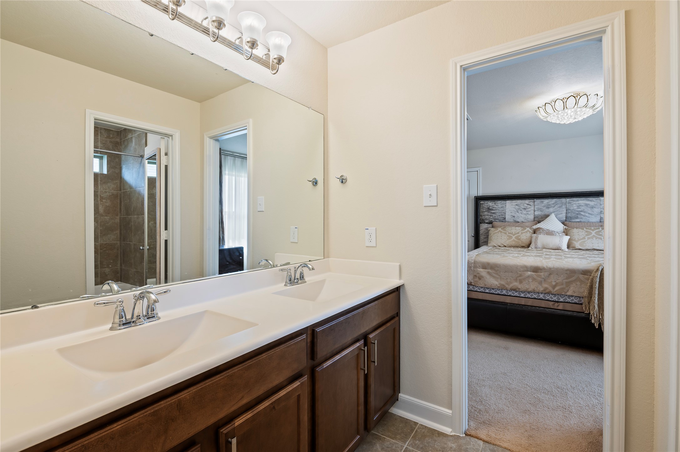 Jack-n-Jill 4th full bathroom features double sinks and private door leading to the tub/shower combo. Ceramic tile and grout recently professionally cleaned upon seller's move out.