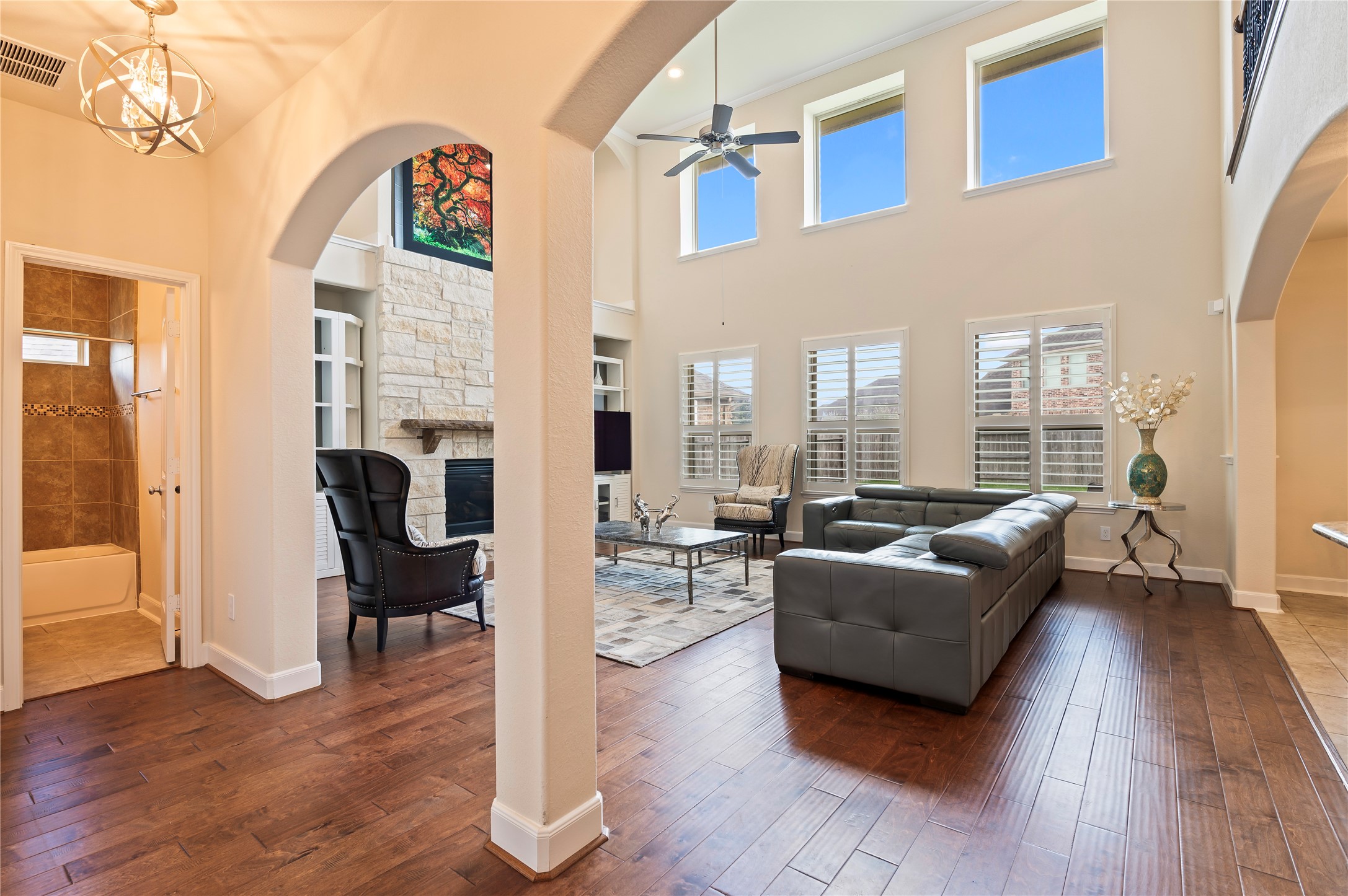 The hardwood floors flow seamlessly into the spacious family room with archways leading to the second bedroom and full bathroom downstairs.