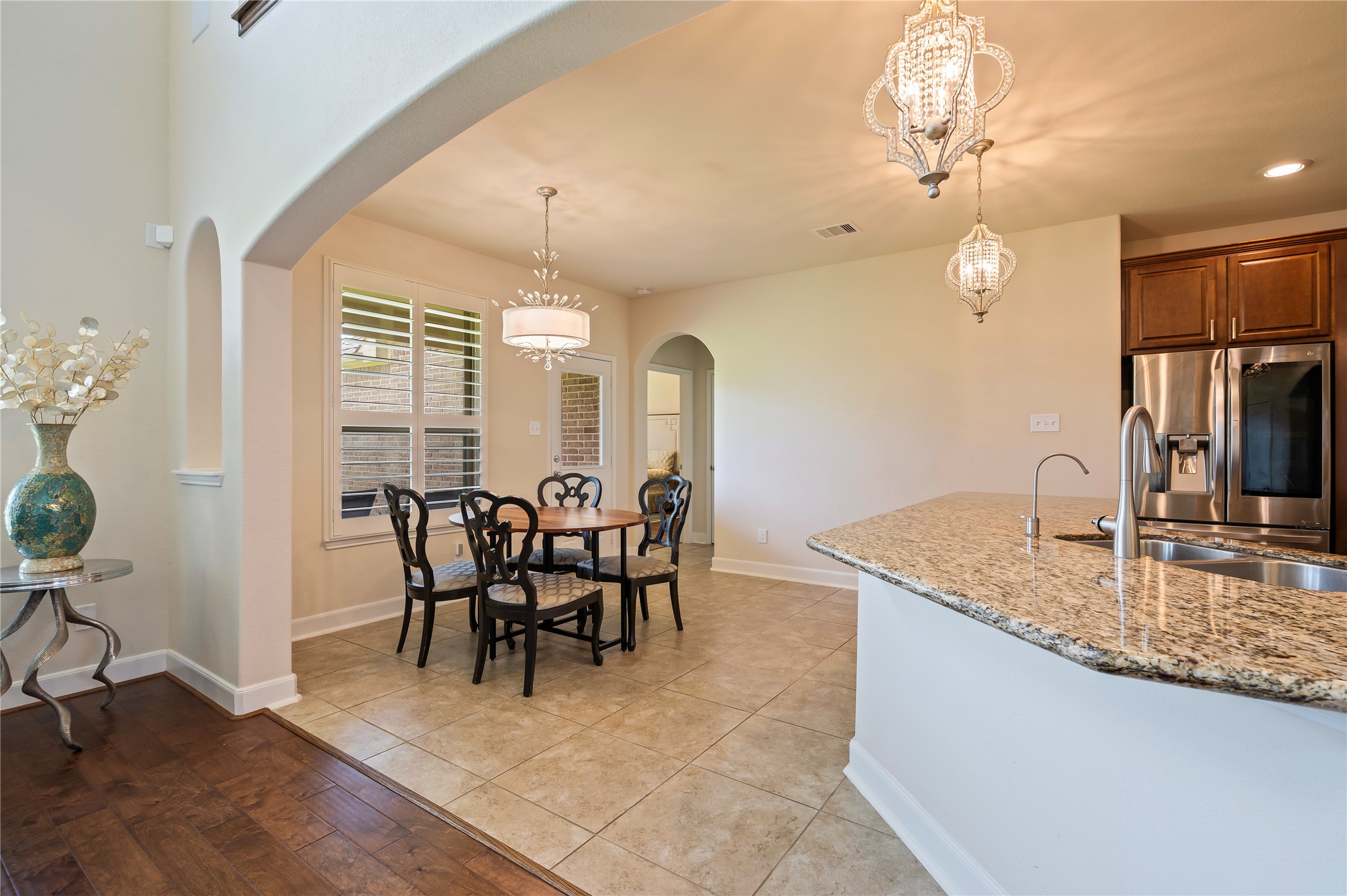 Custom light fixture and plantation shutters in the breakfast area. Kitchen ceramic tile and grout has been professionally cleaned upon seller's move-out.