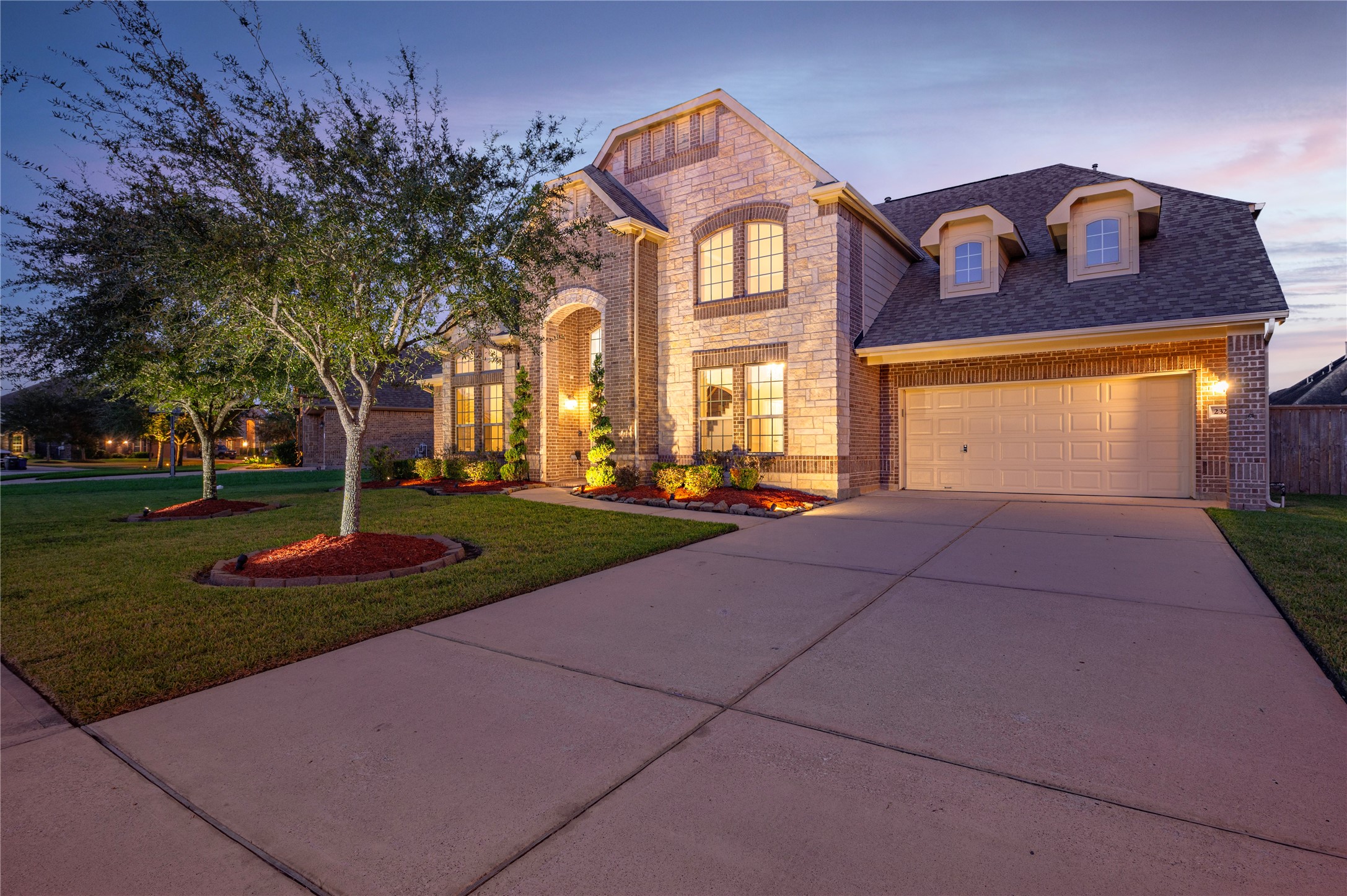 Double wide driveway with spacious 3-car garage provides ample room for vehicles, storage, or a workshop.