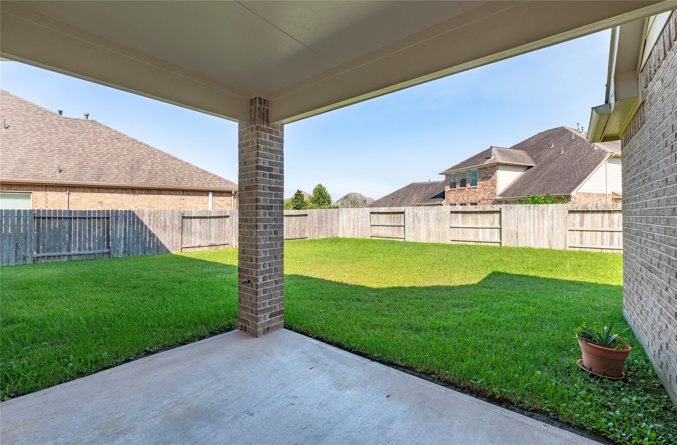 Spacious back covered patio overlooking the backyard.