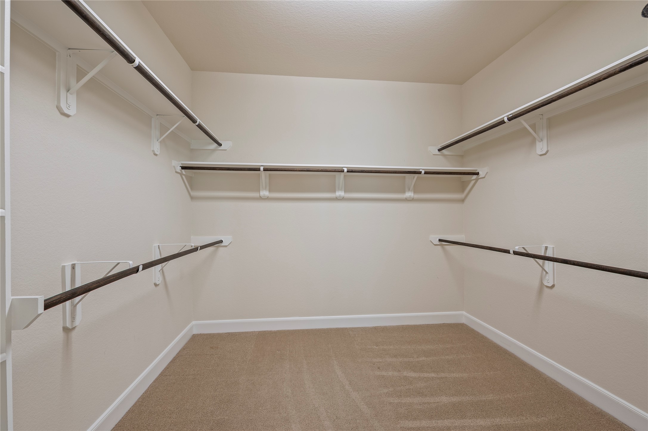 His and hers walk-in closet with built-in storage.