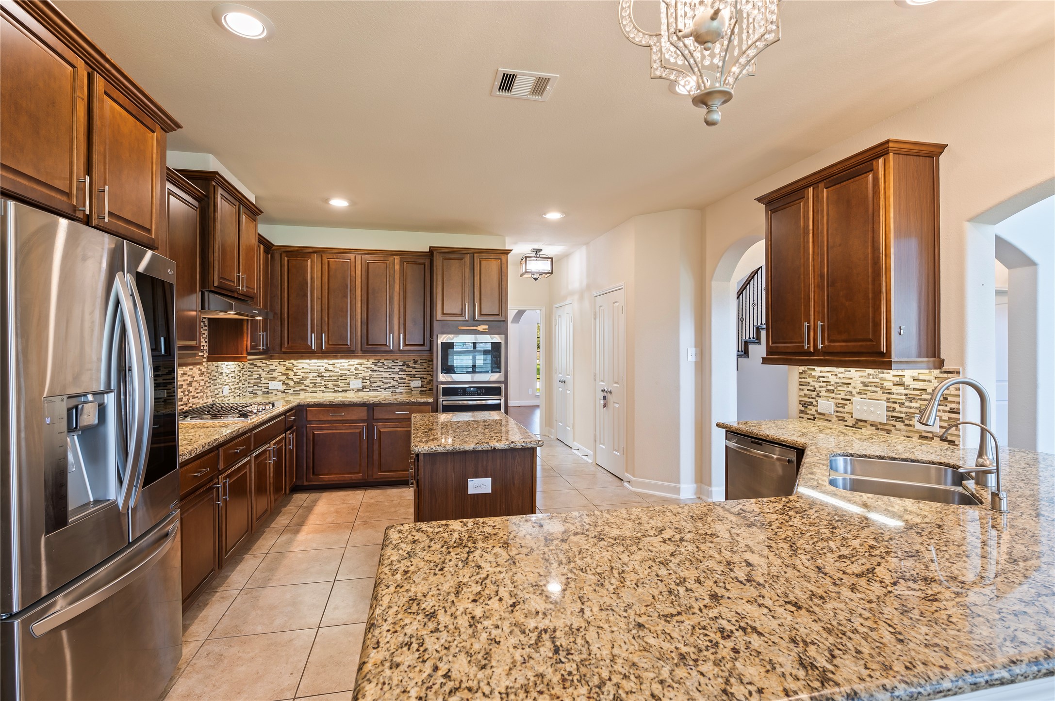 Well appointed kitchen features gorgeous granite countertops, wrap-around breakfast bar and under cabinet lighting.