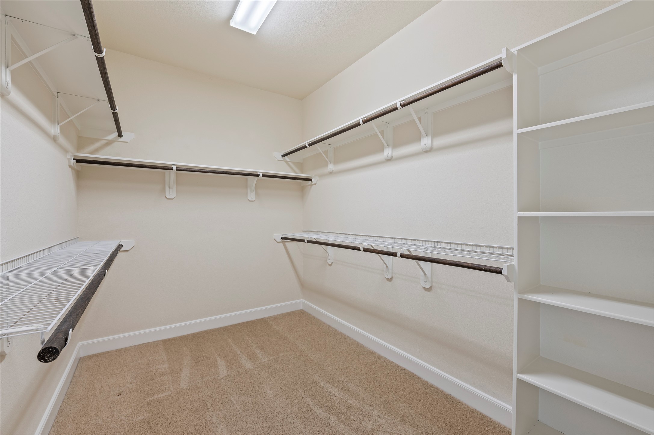 His and hers walk-in closet with built-in storage.