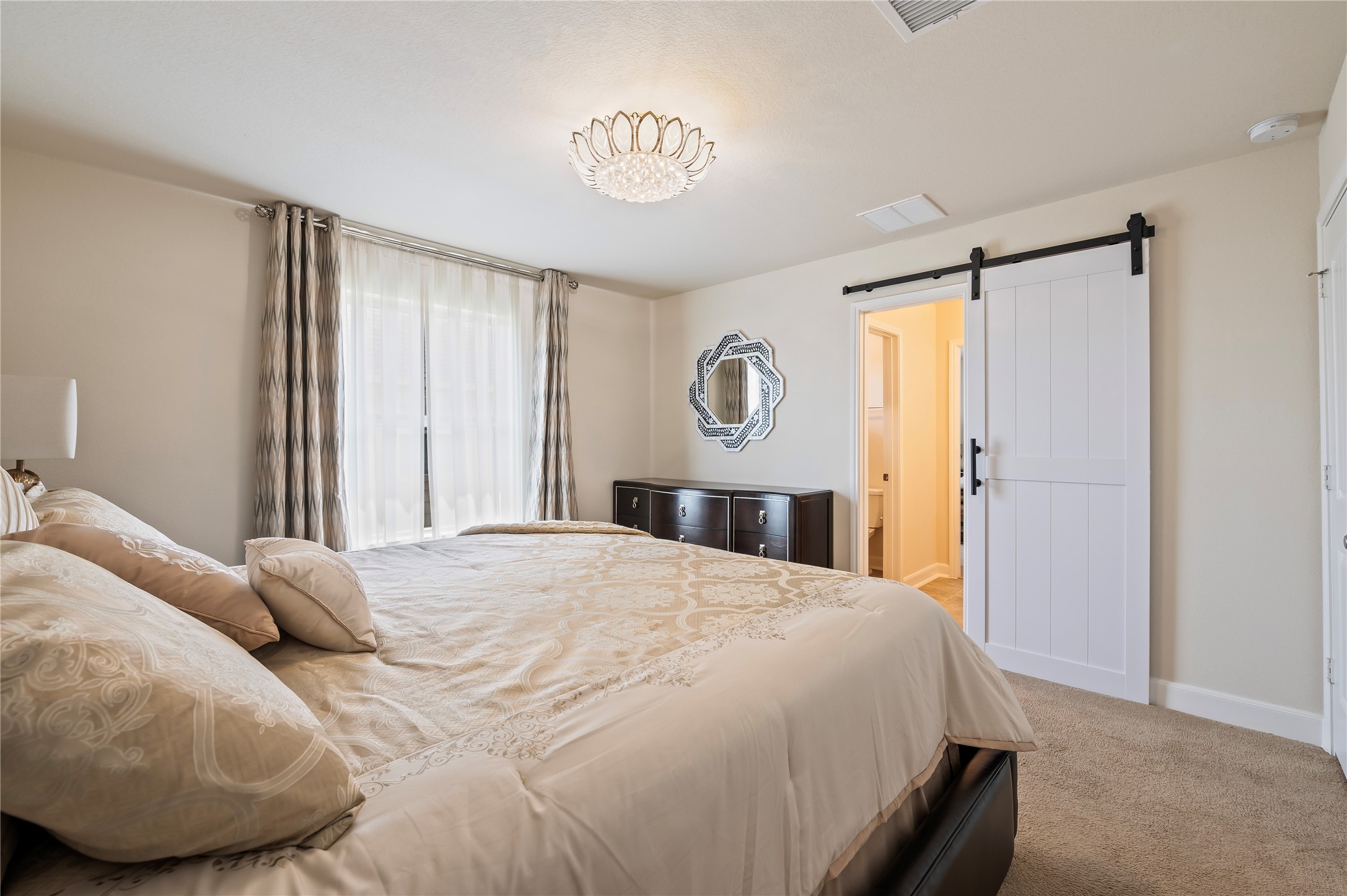 5th bedroom upstairs with custom light fixtures, walk-in closet and custom sliding barn doors leading to Jack-n-Jill bathroom.