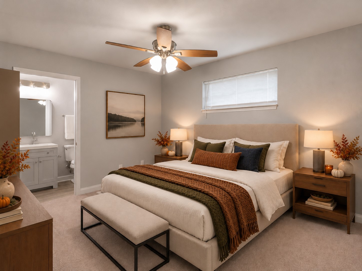 Primary bedroom featuring a ceiling fan, neutral finishes, and an adjoining bathroom. Digitally staged.