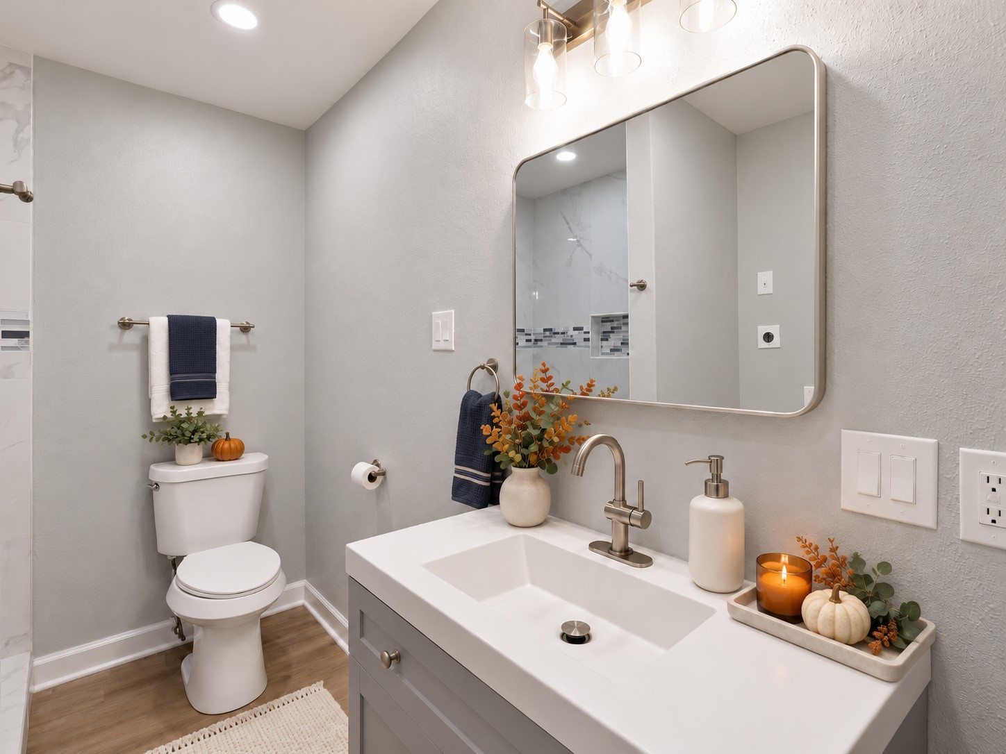 Updated bathroom featuring a modern vanity, framed mirror, and coordinated fixtures. Digitally staged.
