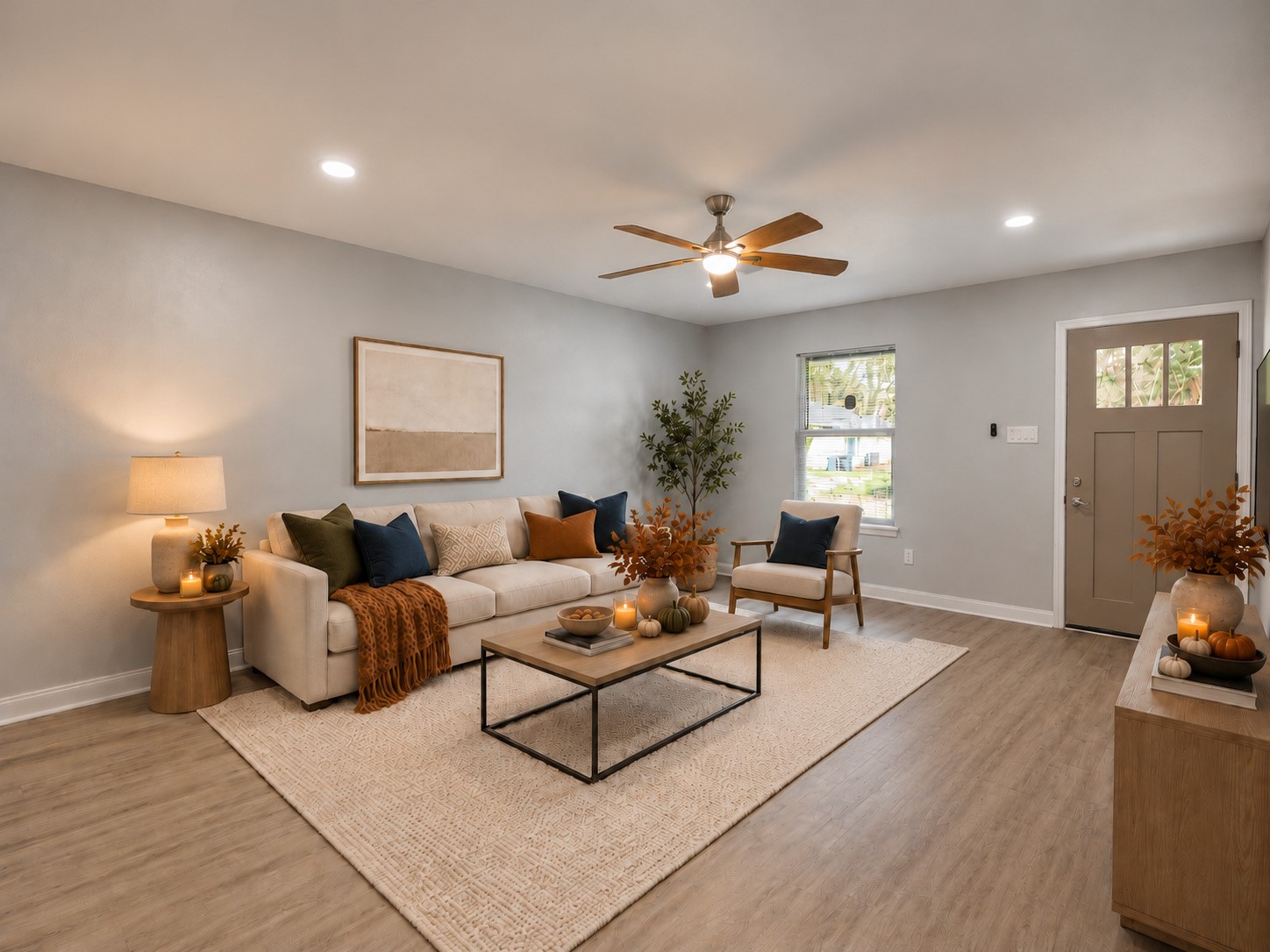 Living room featuring LVP flooring, recessed lighting, and a ceiling fan. Digitally staged.