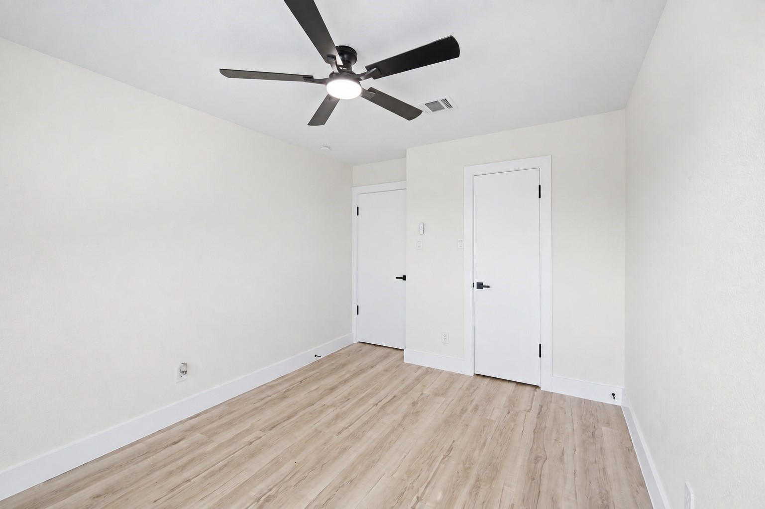 Another angle of the bedroom showcasing the closets